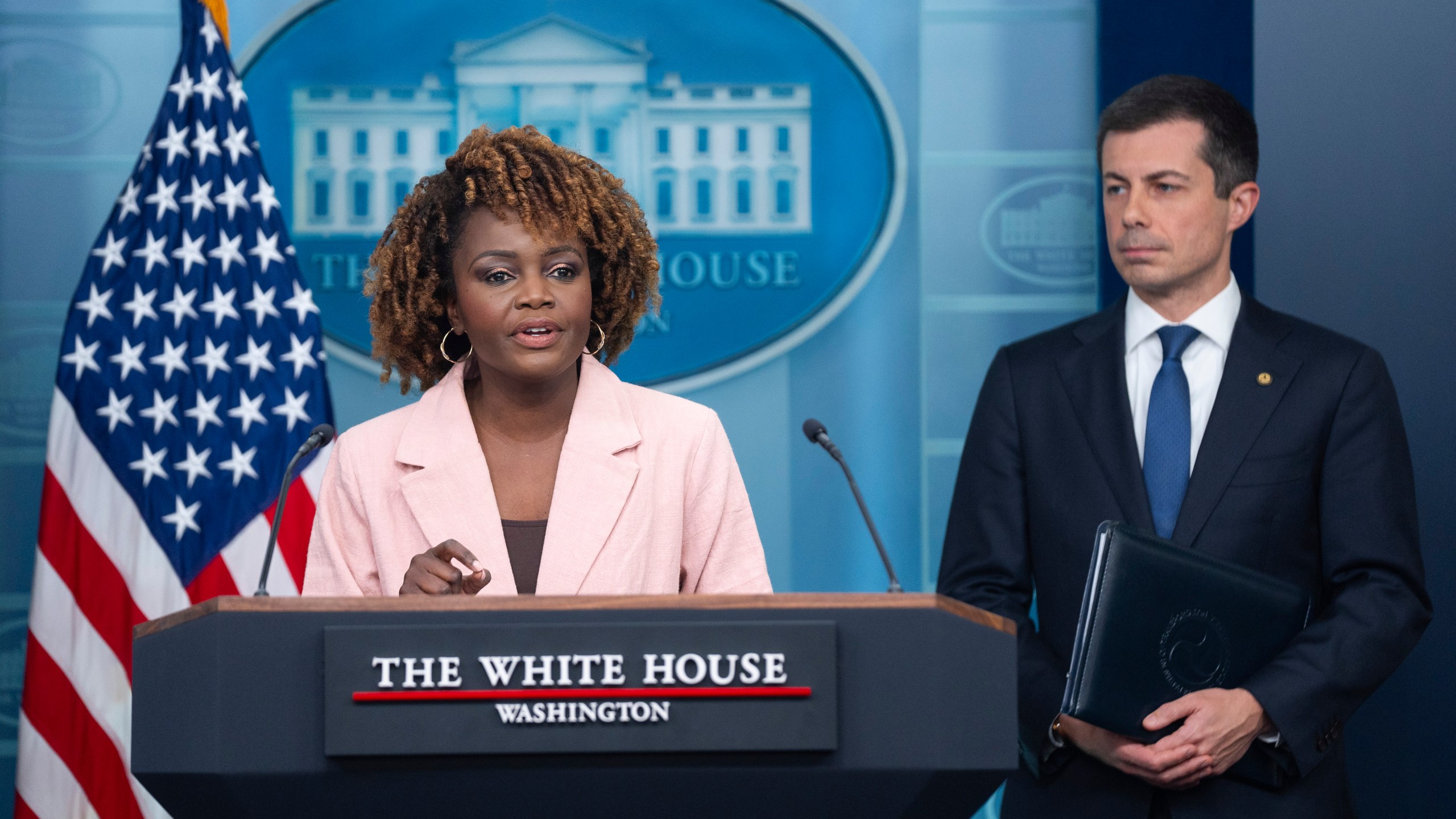 Transportation Secretary Pete Buttigieg listens as White House press secretary Karine Jean-Pierre speaks about the Francis Scott Key Bridge collapse during a press briefing at the White House, Wednesday, March 27, 2024, in Washington. (AP Photo/Evan Vucci)