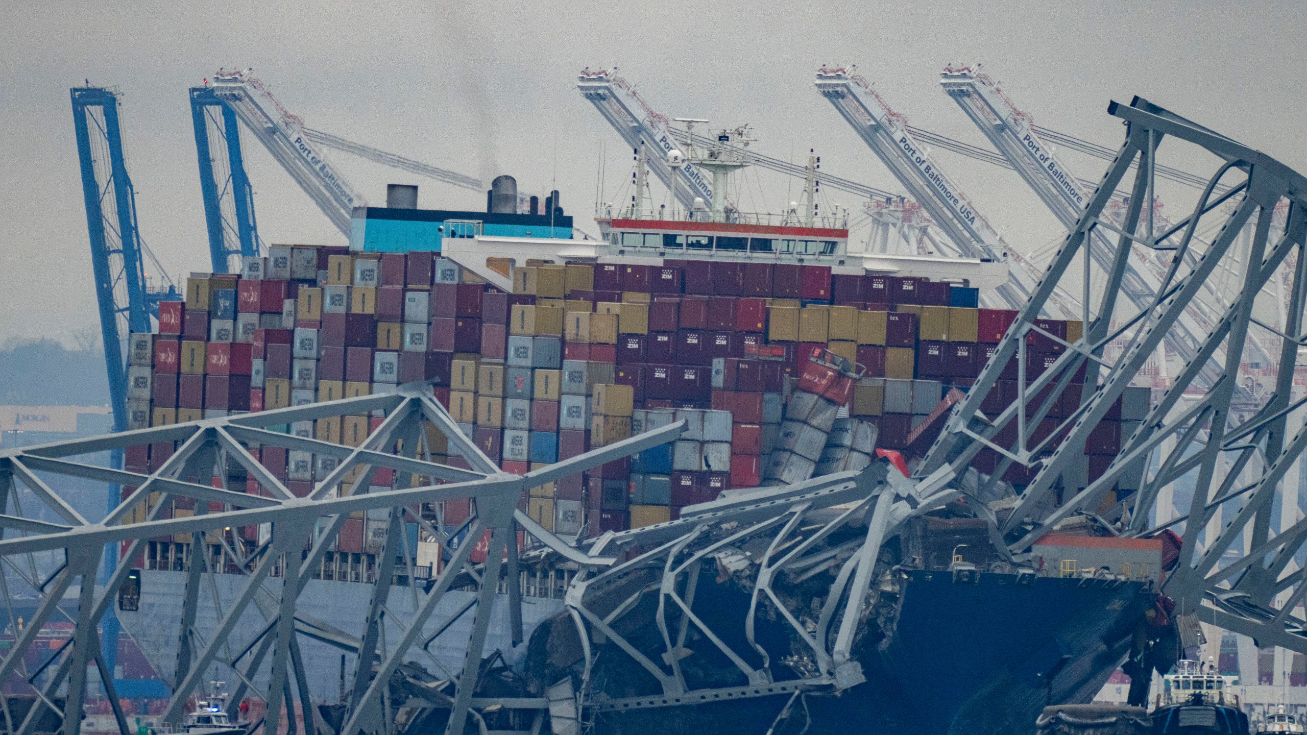 The container ship Dali, owned by Grace Ocean PTE, rests against wreckage of the Francis Scott Key Bridge in the Patapsco River on Wednesday, March 27, 2024, as seen from Pasadena, Md. Investigators began collecting evidence Wednesday from the cargo ship that plowed into Baltimore’s Francis Scott Key Bridge and caused its collapse, while in the waters below divers searched through twisted metal for several construction workers who plunged into the harbor and were feared dead. (AP Photo/Alex Brandon)