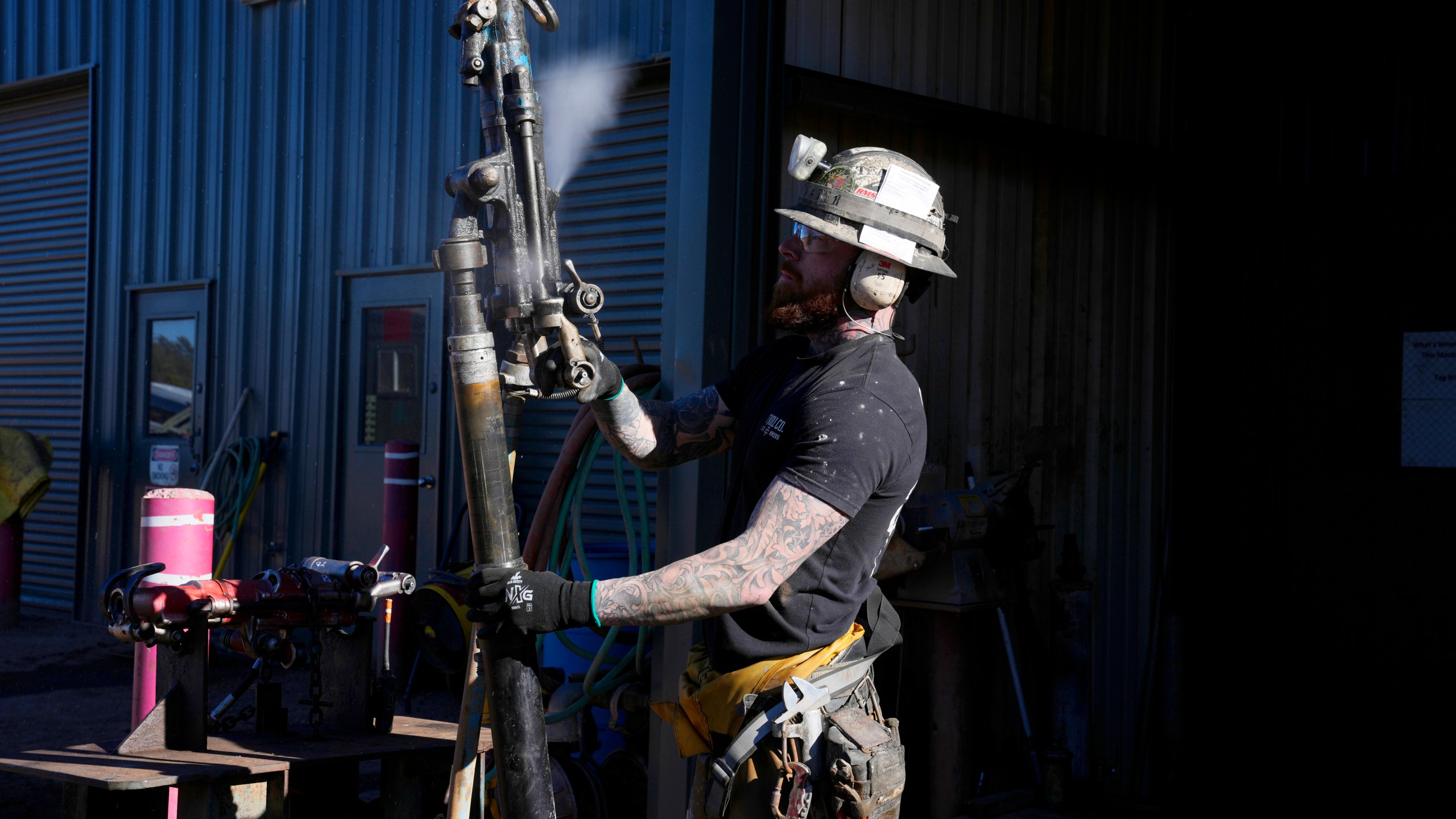 A woker checks on a piece of mining equipment at the Energy Fuels Inc. uranium Pinyon Plain Mine Wednesday, Jan. 31, 2024, near Tusayan, Ariz. The largest uranium producer in the United States is ramping up work just south of Grand Canyon National Park on a long-contested project that largely has sat dormant since the 1980s. (AP Photo/Ross D. Franklin)