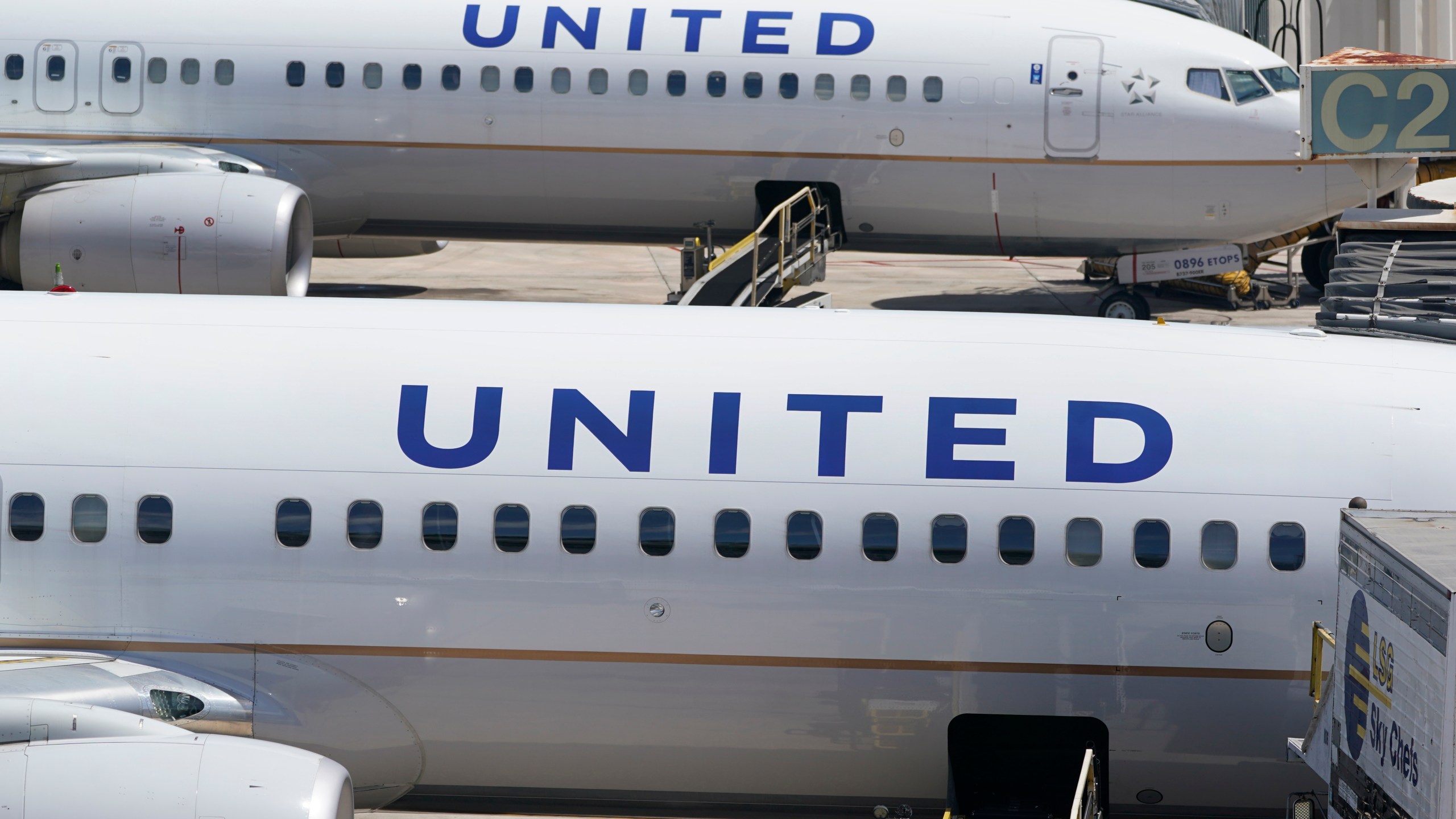 FILE - Two United Airlines Boeing 737s are parked at the gate at the Fort Lauderdale-Hollywood International Airport in Fort Lauderdale, Fla., July 7, 2022. United Airlines is asking its pilots to take time off in May 2024 because of delays in receiving new planes that the airline ordered from Boeing, which is struggling with production due to manufacturing problems. A United spokesperson said Monday, April 1, 2024, that the offer is voluntary. (AP Photo/Wilfredo Lee, File)