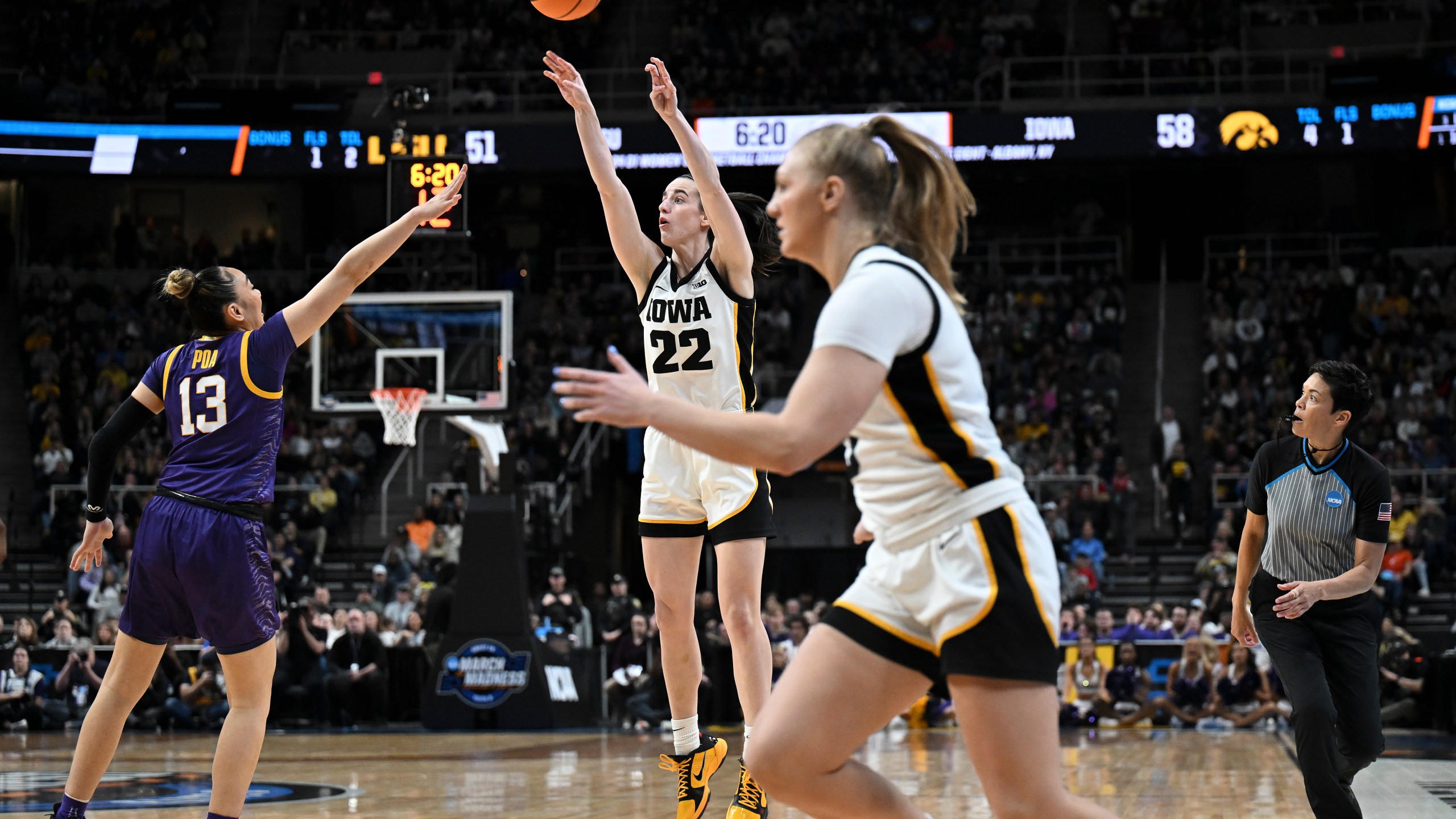 Iowa guard Caitlin Clark (22) puts up a three-point shot against LSU during the third quarter of an Elite Eight round college basketball game during the NCAA Tournament, Monday, April 1, 2024, in Albany, N.Y. (AP Photo/Hans Pennink)