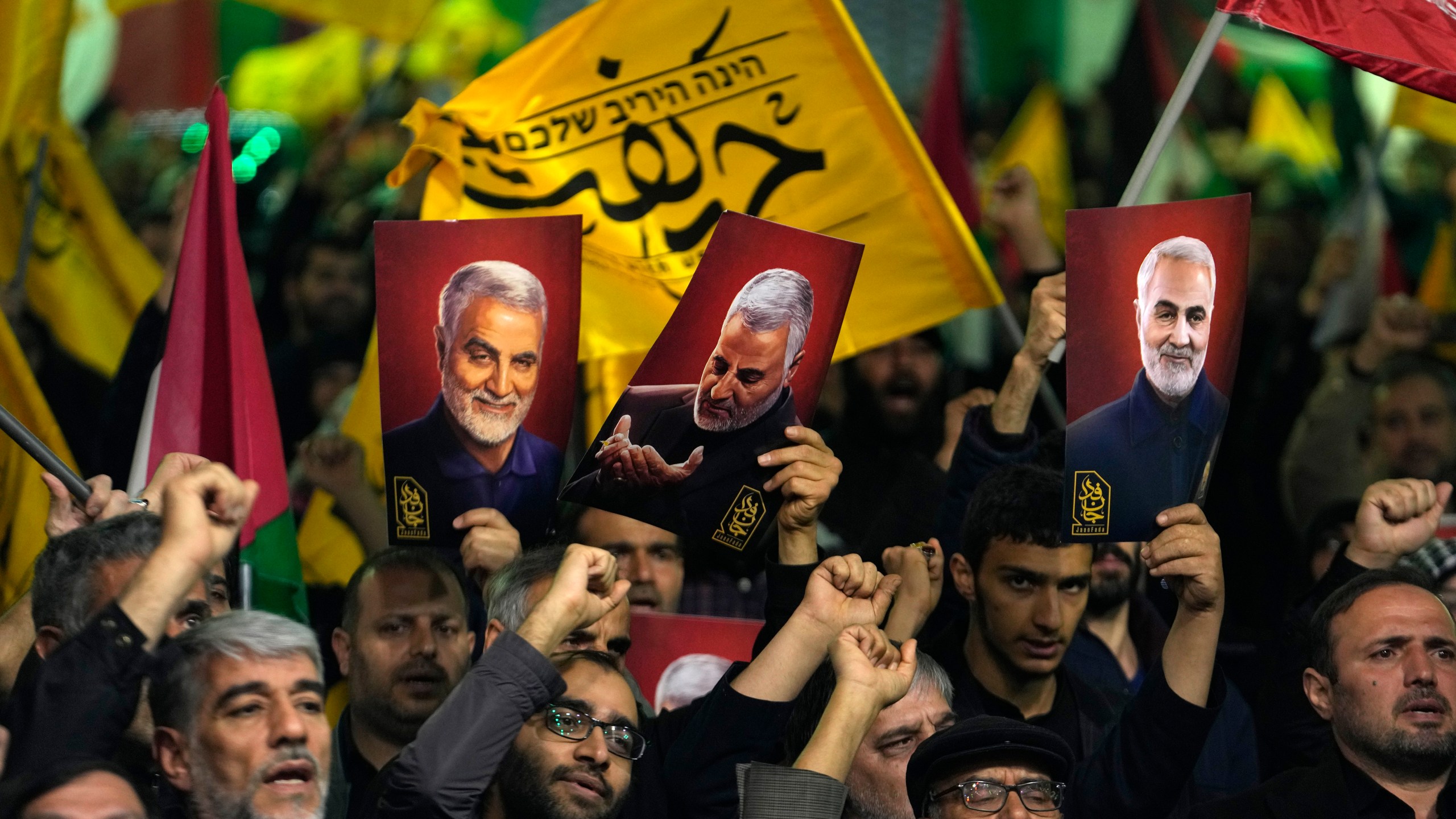 Iranian protesters chant slogans as they hold up posters of the late Iranian Revolutionary Guard Gen. Qassem Soleimani, who was killed in a U.S. drone attack in 2020, during their anti-Israeli gathering to condemn killing members of the Iranian Revolutionary Guard in Syria, at the Felestin (Palestine) Sq. in downtown Tehran, Iran, Monday, April 1, 2024. An Israeli airstrike that demolished Iran's consulate in Syria killed two Iranian generals and five officers, Syrian and Iranian officials said Monday. (AP Photo/Vahid Salemi)