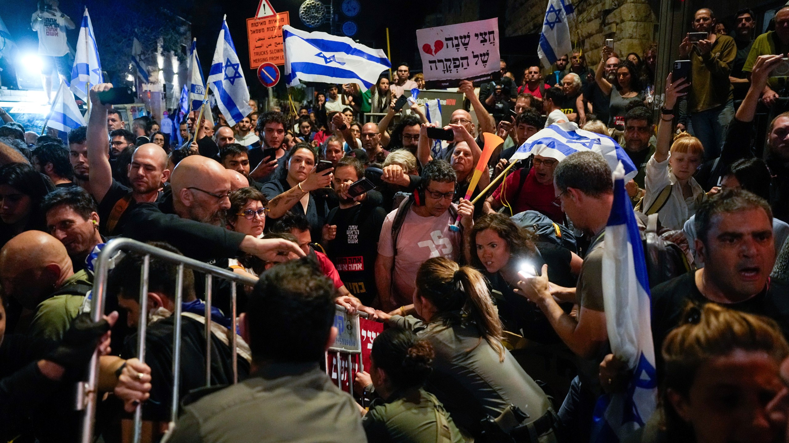 Police try to push back demonstrators in a protest against Israeli Prime Minister Benjamin Netanyahu's government and call for the release of hostages held in the Gaza Strip by the Hamas militant group in Jerusalem, Tuesday, April 2, 2024. (AP Photo/Ohad Zwigenberg)