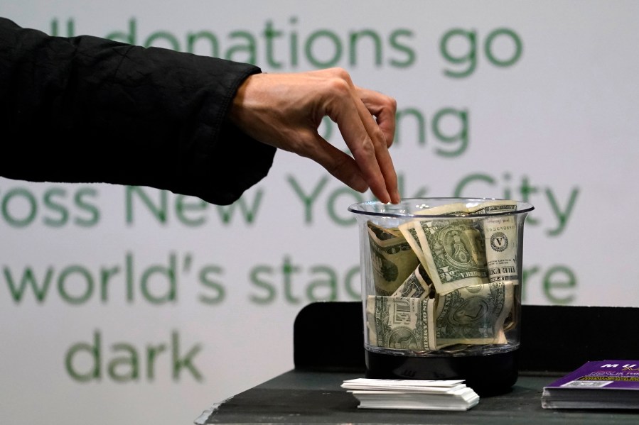 FILE - Money is donated for out of work musicians on March 18, 2021, in New York. At tax time, the three biggest potential deductions for most people are mortgage insurance, charitable donations in cash or in property, and eligible state and local taxes. (AP Photo/Kathy Willens, File)