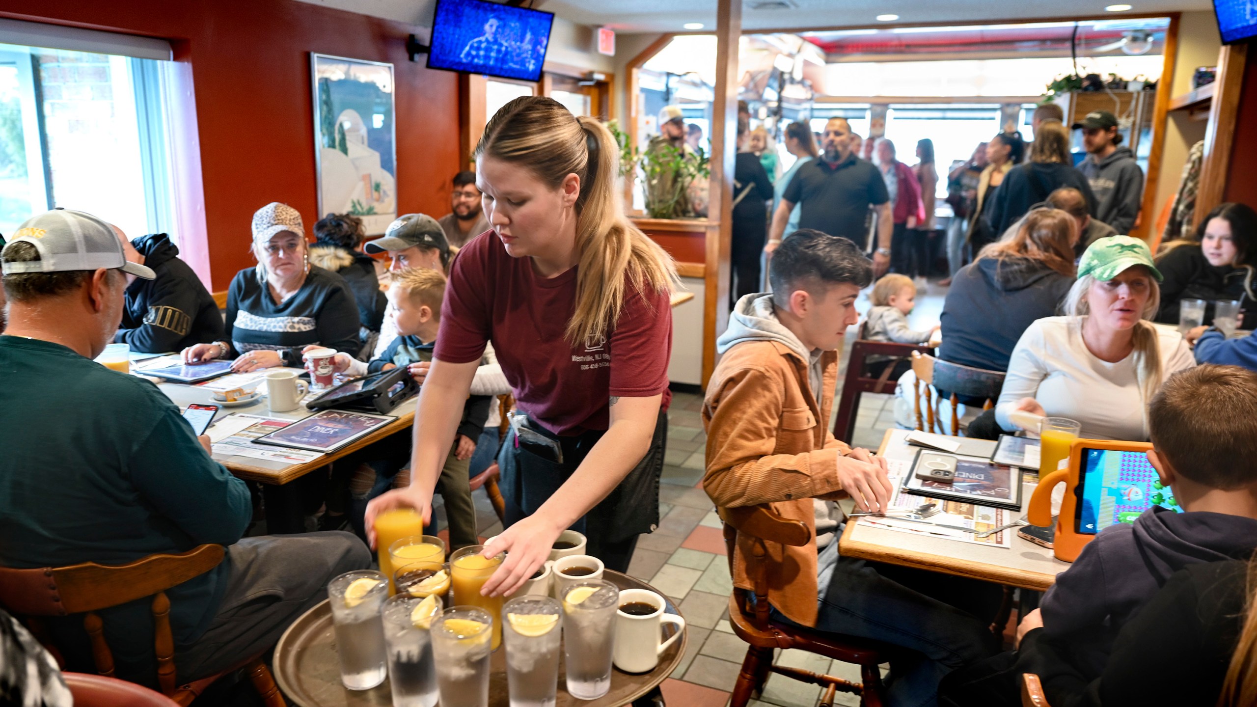 FILE - Waitress Rachel Gurcik serves customers at the Gateway Diner in Westville, Pa. on Oct. 22, 2023. On Friday, April 5, 2024, the U.S. government issues its March jobs report. (Tom Gralish/The Philadelphia Inquirer via AP, File)