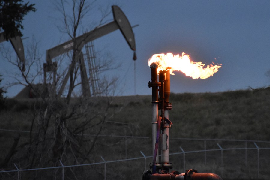 FILE - A flare burns at a well pad Aug. 26, 2021, near Watford City, N.D. The levels of the crucial heat-trapping gases in the atmosphere reached historic highs in 2023, growing at near-record fast paces, according to the U.S. National Oceanic and Atmospheric Administration. (AP Photo/Matthew Brown, File)