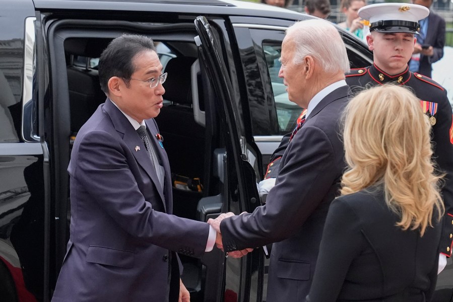 President Joe Biden, center, and first lady Jill Biden greet Japanese Prime Minister Fumio Kishida, left, upon his arrival at the White House, Tuesday, April 9, 2024, in Washington. (AP Photo/Alex Brandon)