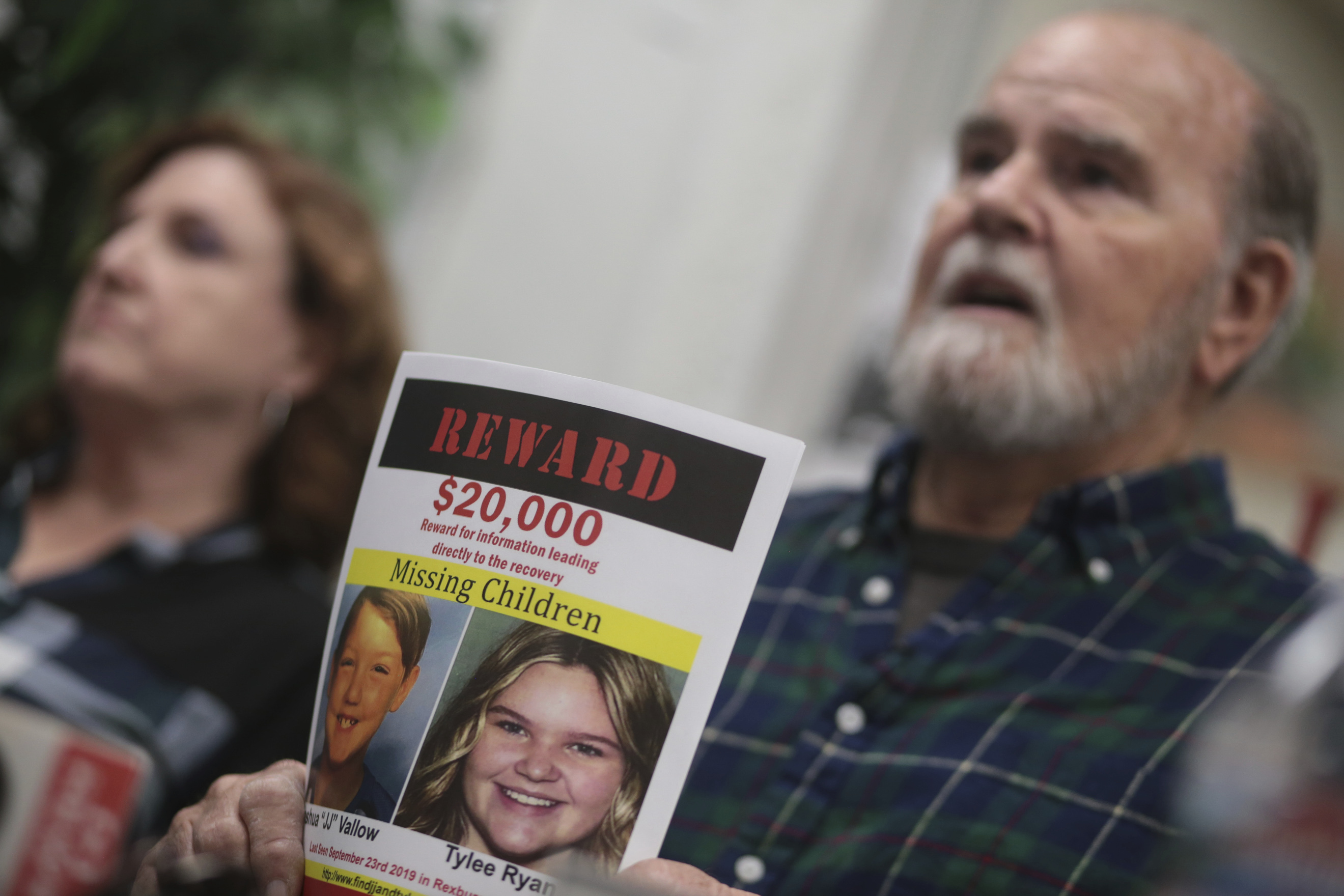 FILE - Larry Woodcock speaks to media members at the Rexburg Standard Journal Newspaper in Rexburg, Idaho on Jan. 7, 2020, while holding a reward flyer for Joshua Vallow and Tylee Ryan. A self-published doomsday fiction author is on trial in Idaho in the deaths of his wife and his new girlfriend's two children. Chad Daybell has pleaded not guilty to murder, conspiracy and grand theft charges in the deaths of his late wife Tammy Daybell, as well as the children, Joshua "JJ" Vallow and Tylee Ryan. (John Roark/The Idaho Post-Register via AP, File)