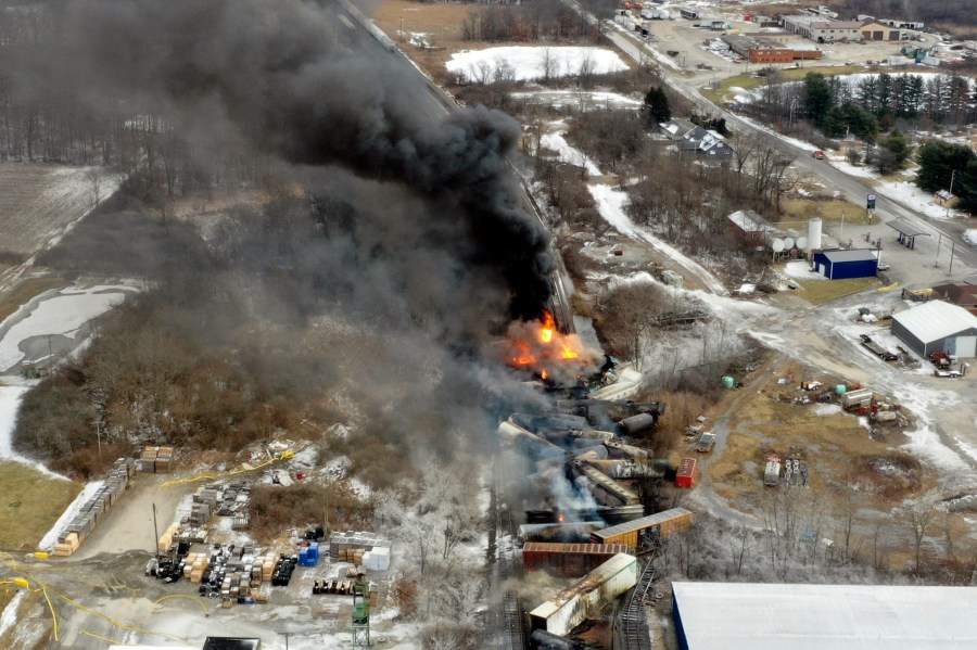 FILE - This image taken with a drone shows portions of a Norfolk Southern freight train Saturday, Feb. 4, 2023, that still burns after it derailed the night before in East Palestine, Ohio. The lawyers who negotiated a $600 million settlement with Norfolk Southern over that railroad's disastrous 2023 derailment in eastern Ohio want residents to talk with them before deciding the historic deal isn't enough. (AP Photo/Gene J. Puskar, File)