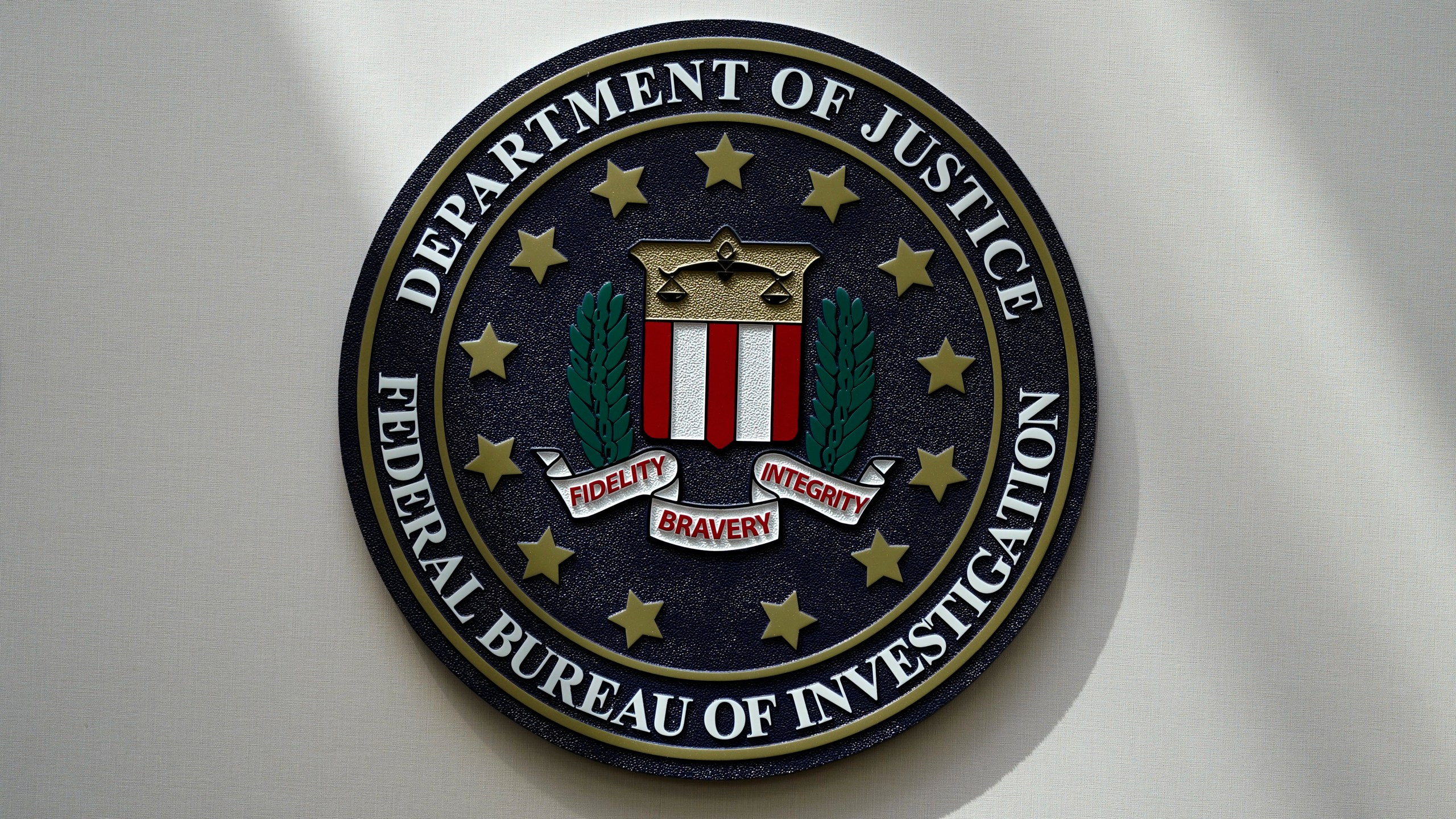 FILE - An FBI seal is seen on a wall on Aug. 10, 2022, in Omaha, Neb. The House was holding a key test vote Wednesday, April 10, 2024, on whether to consider a bill that would reauthorize a crucial national security surveillance program, but the prospects were uncertain amid intense Republican opposition as well as an edict earlier in the day from former President Donald Trump to “kill" the measure. Johnson has called the program “critically important” but has struggled to find a path forward on the issue, which has been plagued by partisan bickering for years. (AP Photo/Charlie Neibergall, File)