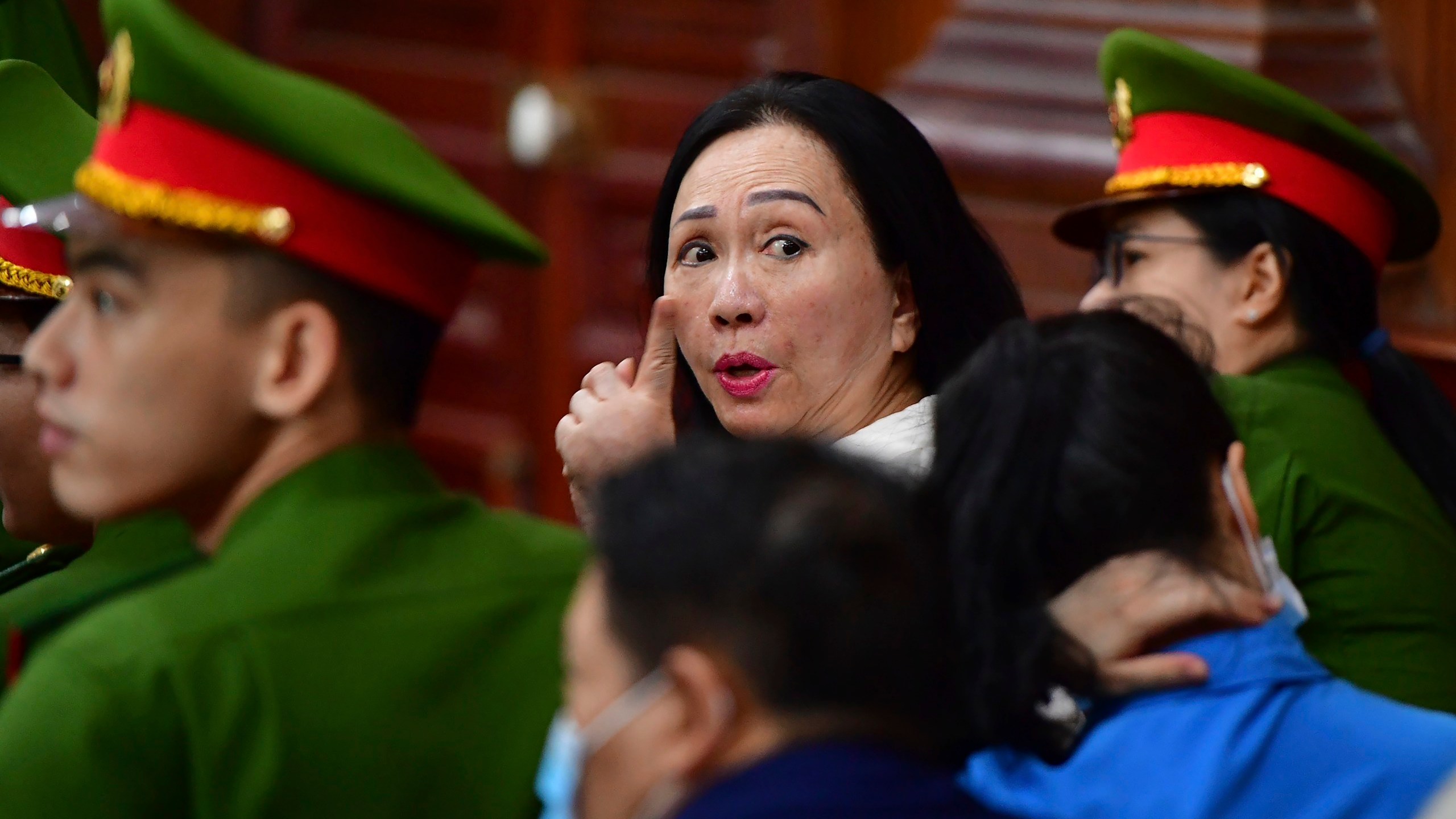 Business woman Truong My Lan, center, attends a trial in Ho Chi Minh City, Vietnam on Thursday, April 11, 2024. The real estate tycoon may face the death penalty if convicted of allegations that she siphoned off an amount of $12.5 billion, nearly 3 percent of Vietnam's 2022 GDP, in its largest financial fraud case. (Thanh Tung/VnExpress via AP)