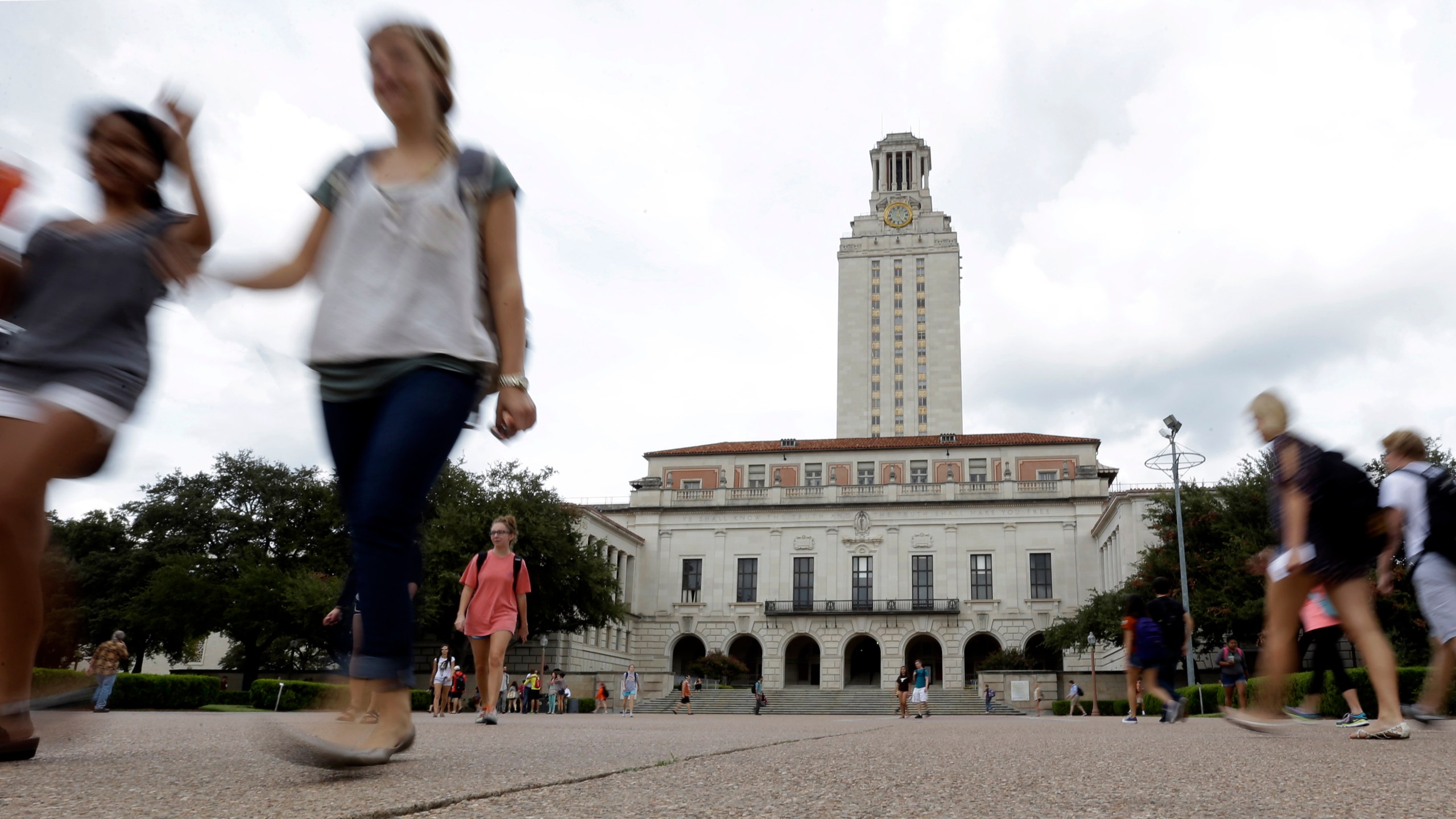 FILE - In this Sept. 27, 2012, file photo, students walk through the University of Texas at Austin campus near the school's iconic tower in Austin, Texas. A ban on diversity, equity and inclusion initiatives in higher education has led to more than 100 job cuts across university campuses in Texas, a hit echoed or anticipated in numerous other states where lawmakers are rolling out similar policies during an important election year. (AP Photo/Eric Gay, File)