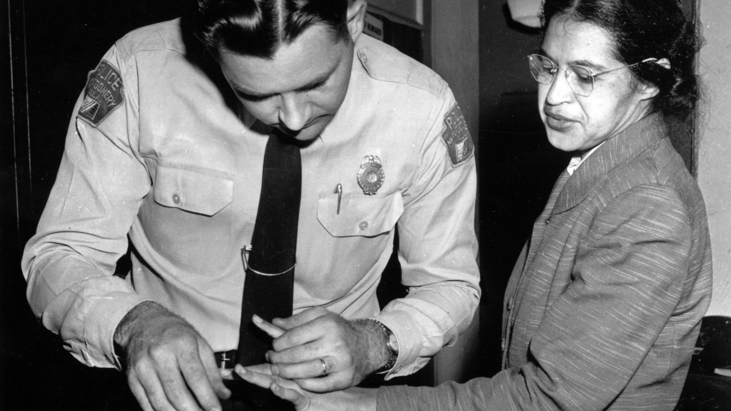 FILE - Rosa Parks is fingerprinted by police Lt. D.H. Lackey in Montgomery, Ala., Feb. 22, 1956, two months after refusing to give up her seat on a bus for a white passenger on Dec. 1, 1955. Gene Herrick, a retired Associated Press photographer who covered the Korean War and is known for his iconic images of Martin Luther King Jr., Rosa Parks and the trial of the killers of Emmett Till in the early years of the Civil Rights Movement, died Friday, April 12, 2024. He was 97. (AP Photo/Gene Herrick, File)