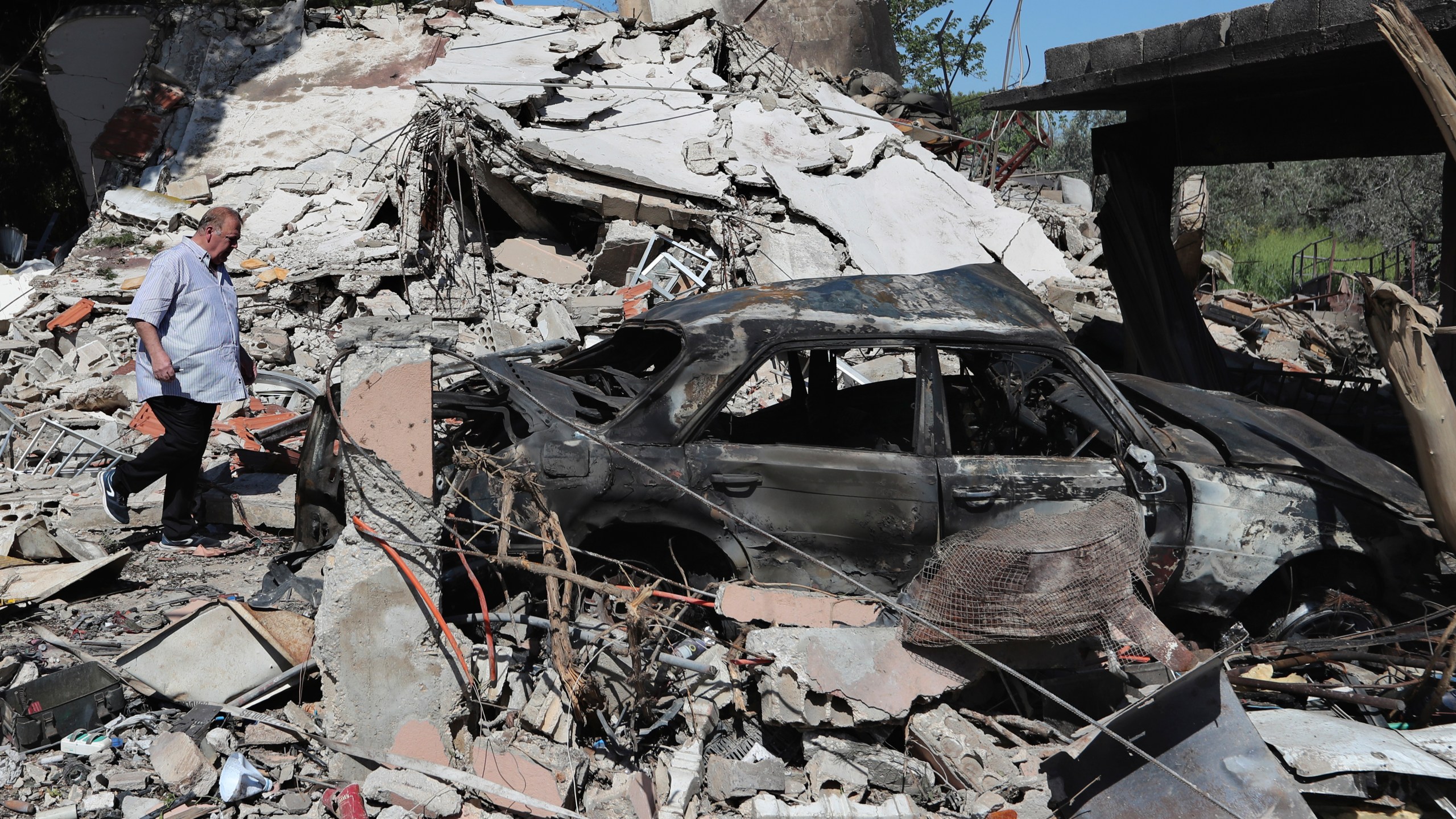 A Lebanese man checks a destroyed house that was hit by an Israeli airstrike, in Alma al-Shaab, a Lebanese border village with Israel, south Lebanon, Wednesday, April 17, 2024. Hezbollah militants and Israeli forces have been exchanging fire since a day after the Israel-Hamas war began on Oct. 7. (AP Photo/Mohammed Zaatari)