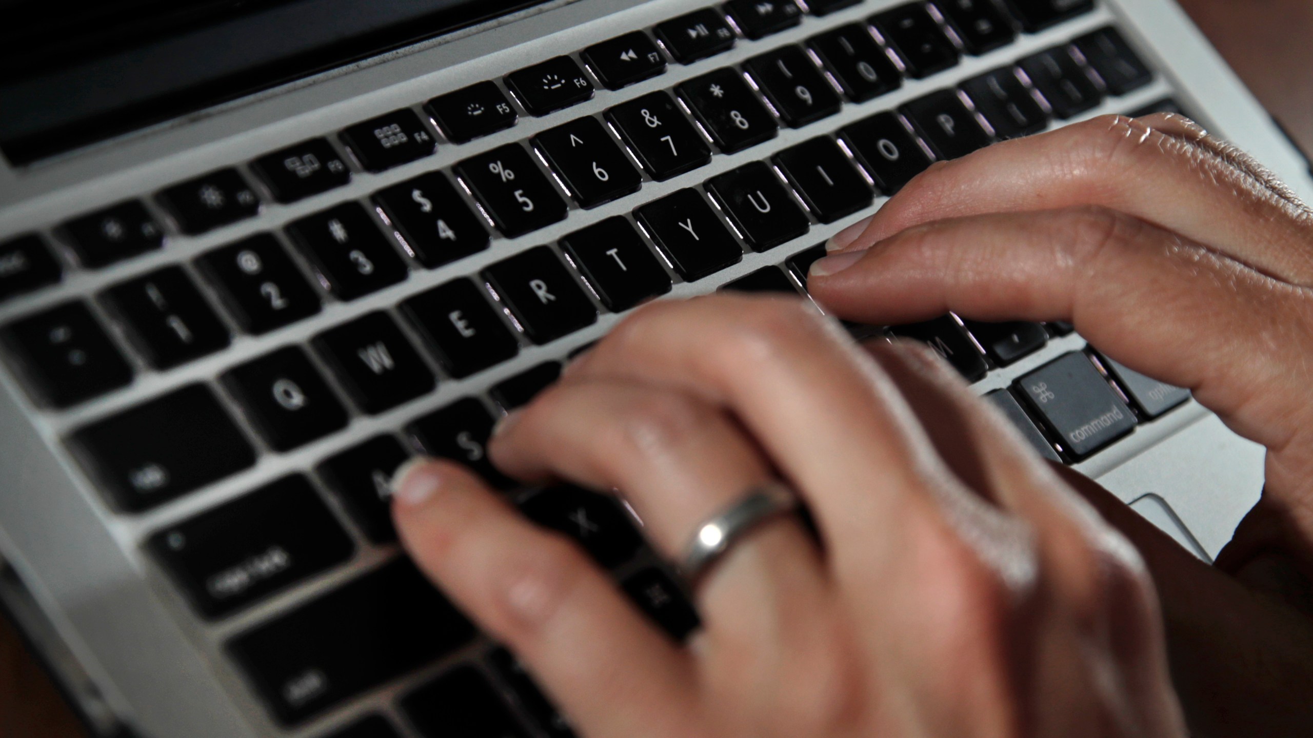 FILE - A person works on a laptop on June 19, 2017, in North Andover, Mass. As more of our lives move online, our personal data like email addresses, phone numbers, birthdates and even passcodes are becoming ever more vulnerable to theft or being mistakenly exposed. (AP Photo/Elise Amendola, File)