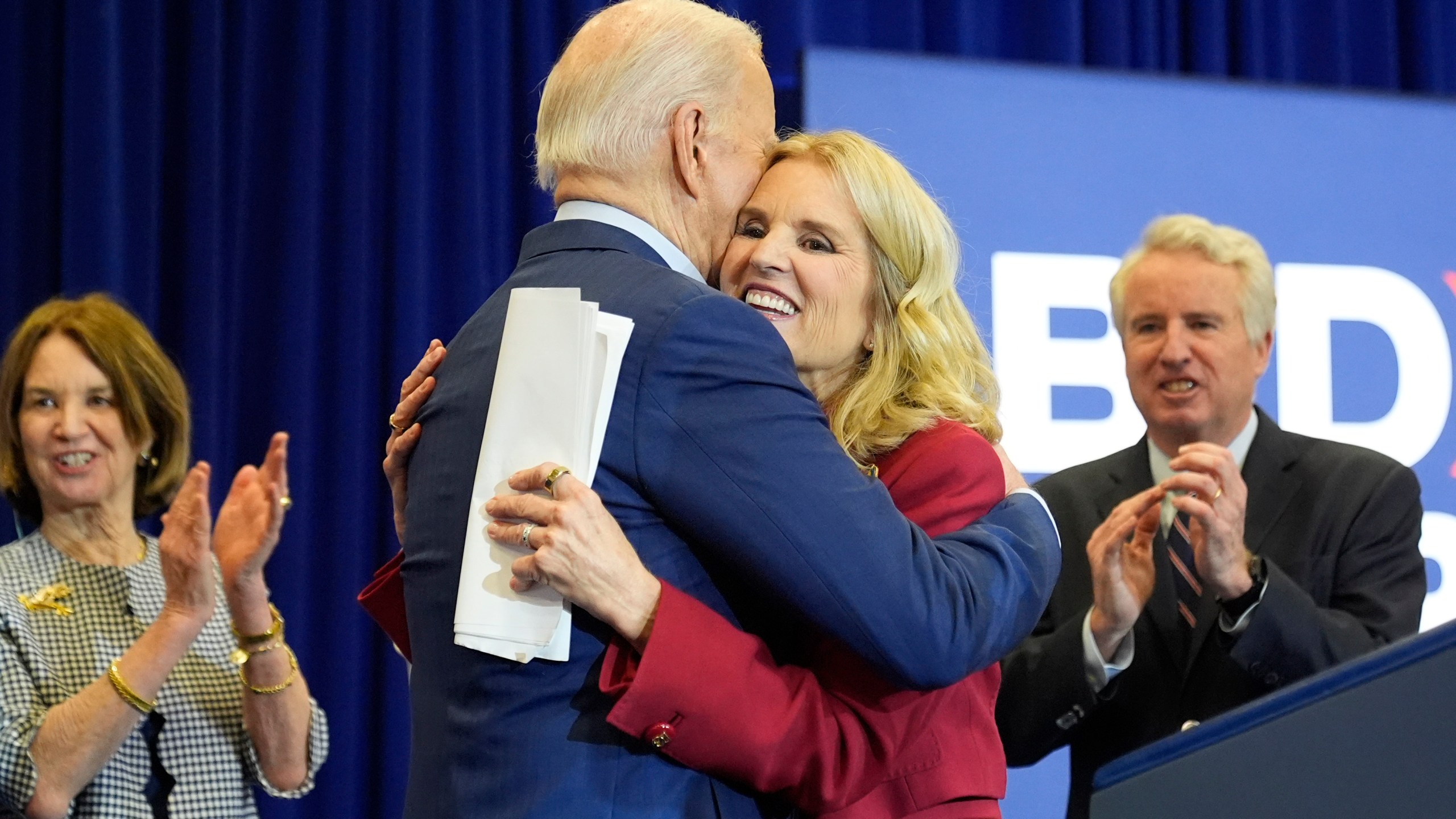 Kerry Kennedy, right, hugs President Joe Biden at a campaign event, Thursday, April 18, 2024, in Philadelphia. Pictured from left are members of the Kennedy family Kathleen Kennedy Townsend and Christopher Kennedy. (AP Photo/Alex Brandon)