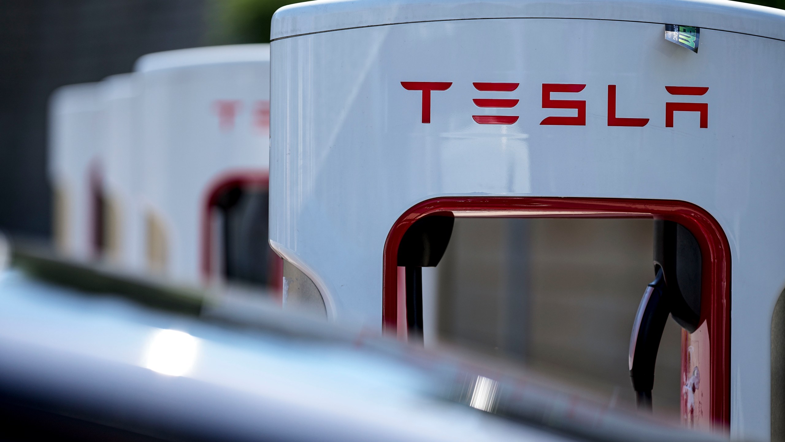 FILE - A Tesla charging station is seen, Sept. 28, 2023, in Woodstock, Ga. Tesla knocked roughly a third off the price of its “Full Self Driving” system, which can’t drive itself and so drivers must remain alert and be ready to intervene, to $8,000 from $12,000, according to the company website. (AP Photo/Mike Stewart, File)