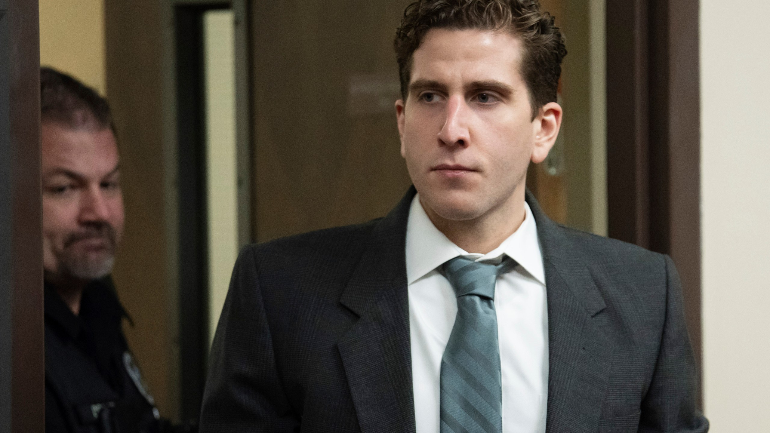 FILE - Bryan Kohberger, right, is escorted into a courtroom for a hearing in Latah County District Court, Sept. 13, 2023, in Moscow, Idaho. A judge says defense attorneys for Kohberger, the man charged in the deaths of four University of Idaho students in late 2022, can resume phone surveys of potential jurors in the case. (AP Photo/Ted S. Warren, Pool, File)