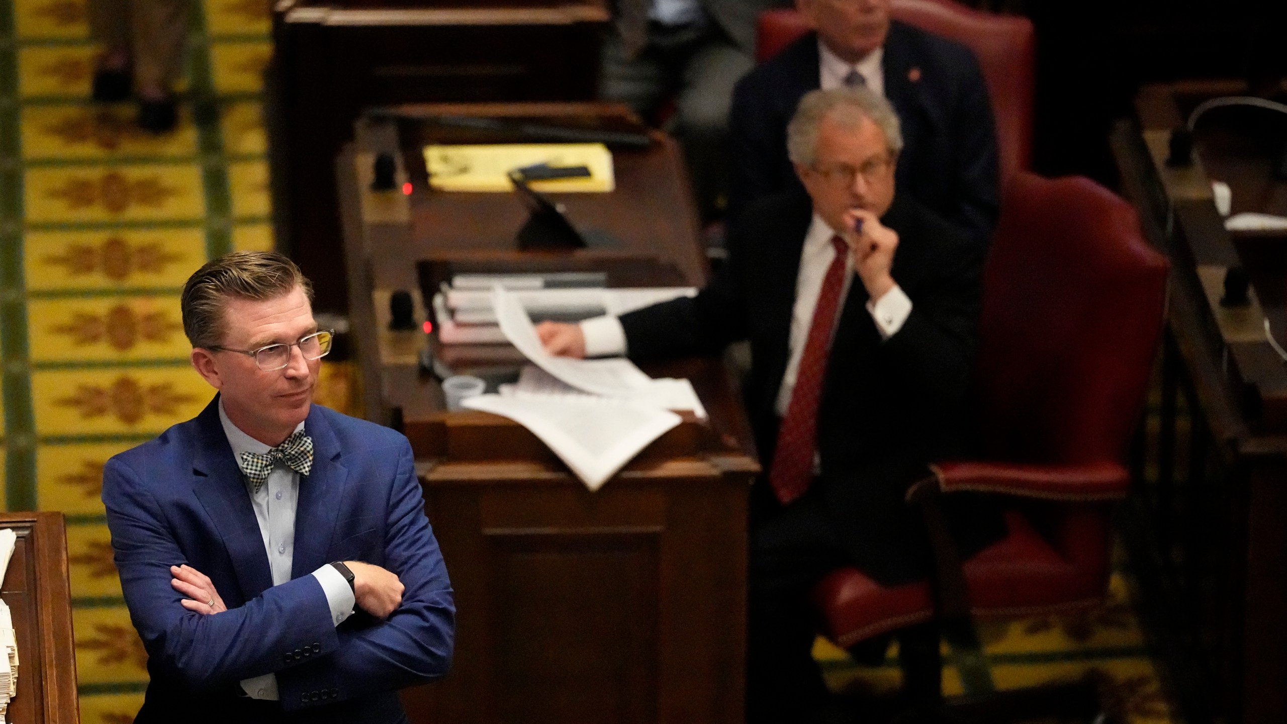 Rep. Ryan Williams, R-Cookeville, left, listens to debate of his bill to allow some teachers to be armed in schools on the House floor during a legislative session Tuesday, April 23, 2024, in Nashville, Tenn. (AP Photo/George Walker IV)