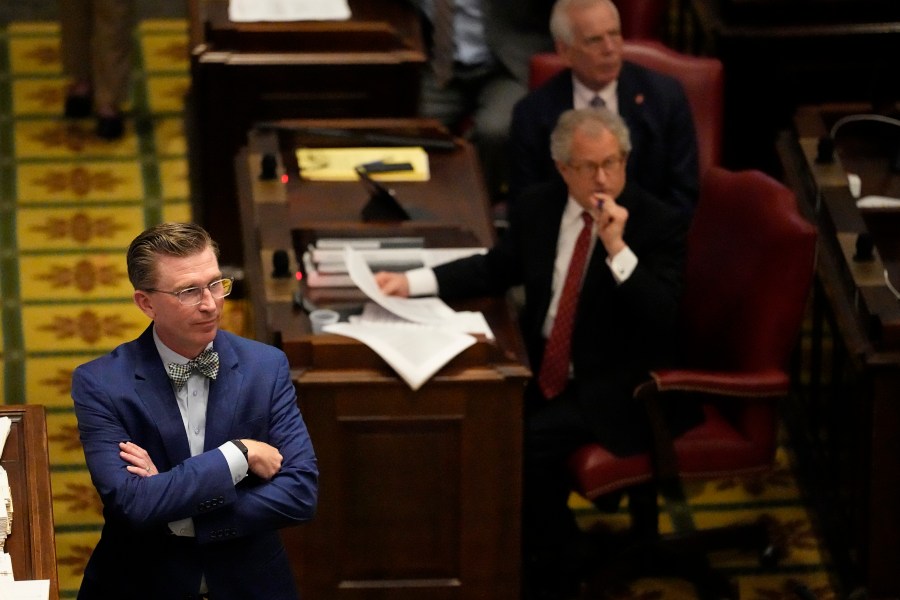 Rep. Ryan Williams, R-Cookeville, left, listens to debate of his bill to allow some teachers to be armed in schools on the House floor during a legislative session Tuesday, April 23, 2024, in Nashville, Tenn. (AP Photo/George Walker IV)