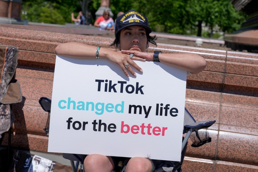 A TikTok content creator, sits outside the U.S. Capitol, Tuesday, April 23, 2024, in Washington as Senators prepare to consider legislation that would force TikTok's China-based parent company to sell the social media platform under the threat of a ban, a contentious move by U.S. lawmakers. (AP Photo/Mariam Zuhaib)