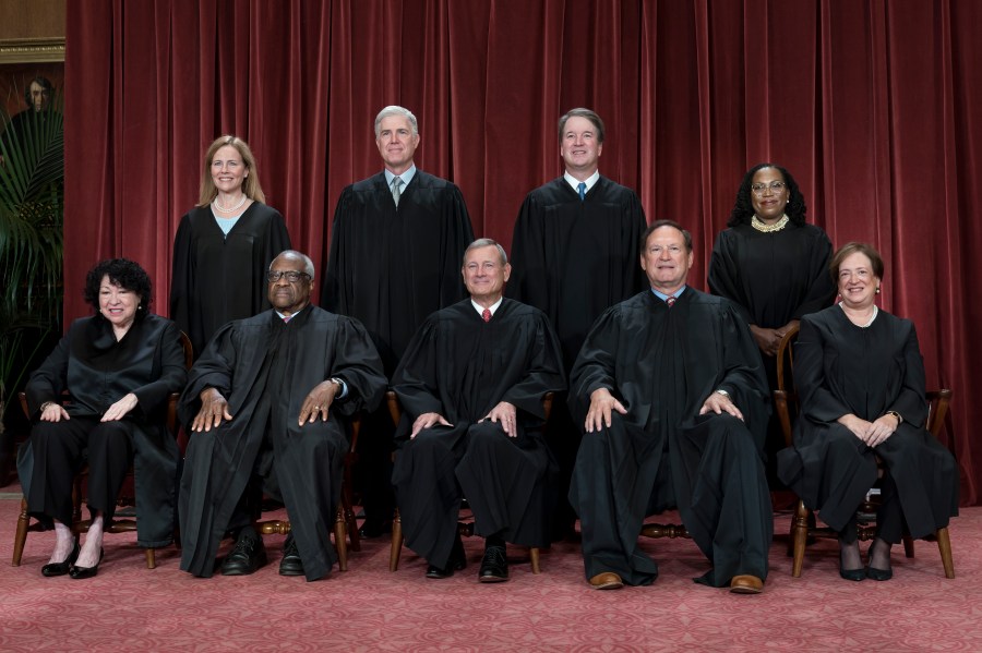 FILE - Members of the Supreme Court sit for a new group portrait following the addition of Associate Justice Ketanji Brown Jackson, at the Supreme Court building in Washington, on Oct. 7, 2022. Bottom row, from left, Associate Justice Sonia Sotomayor, Associate Justice Clarence Thomas, Chief Justice of the United States John Roberts, Associate Justice Samuel Alito, and Associate Justice Elena Kagan. Top row, from left, Associate Justice Amy Coney Barrett, Associate Justice Neil Gorsuch, Associate Justice Brett Kavanaugh, and Associate Justice Ketanji Brown Jackson. The core issue being debated before the Supreme Court on April 25, 2024, boils down to this: Whether a former president is immune from prosecution for actions taken while in office — and, if so, what is the extent of the immunity? (AP Photo/J. Scott Applewhite)