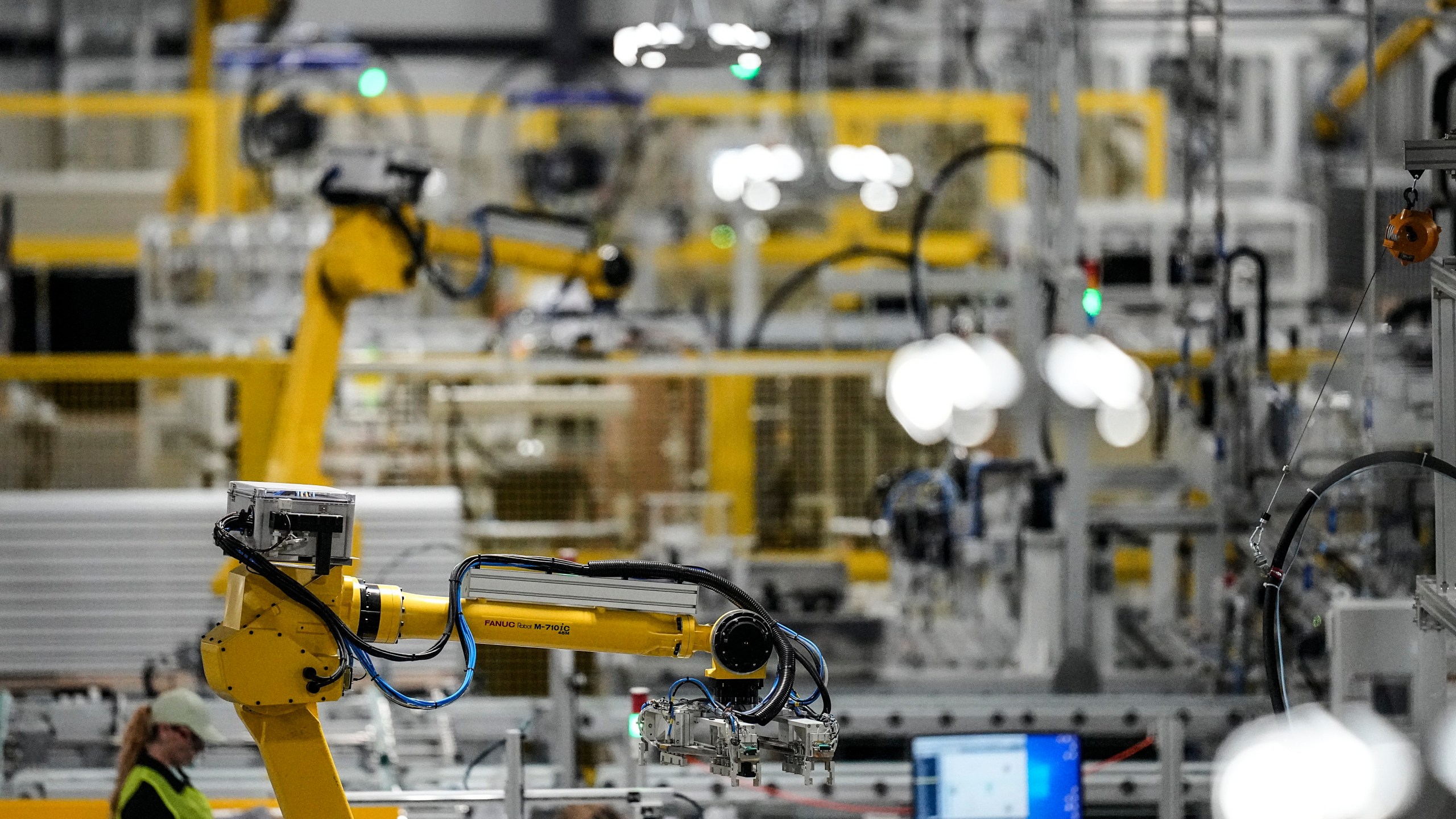 FILE - Articulated robots move inside the Hanwha Qcells Solar plant, Oct. 16, 2023, in Dalton, Ga. On Thursday, April 25, 2024, the U.S. government issues the first of three estimates of economic growth in the first quarter. (AP Photo/Mike Stewart, File)