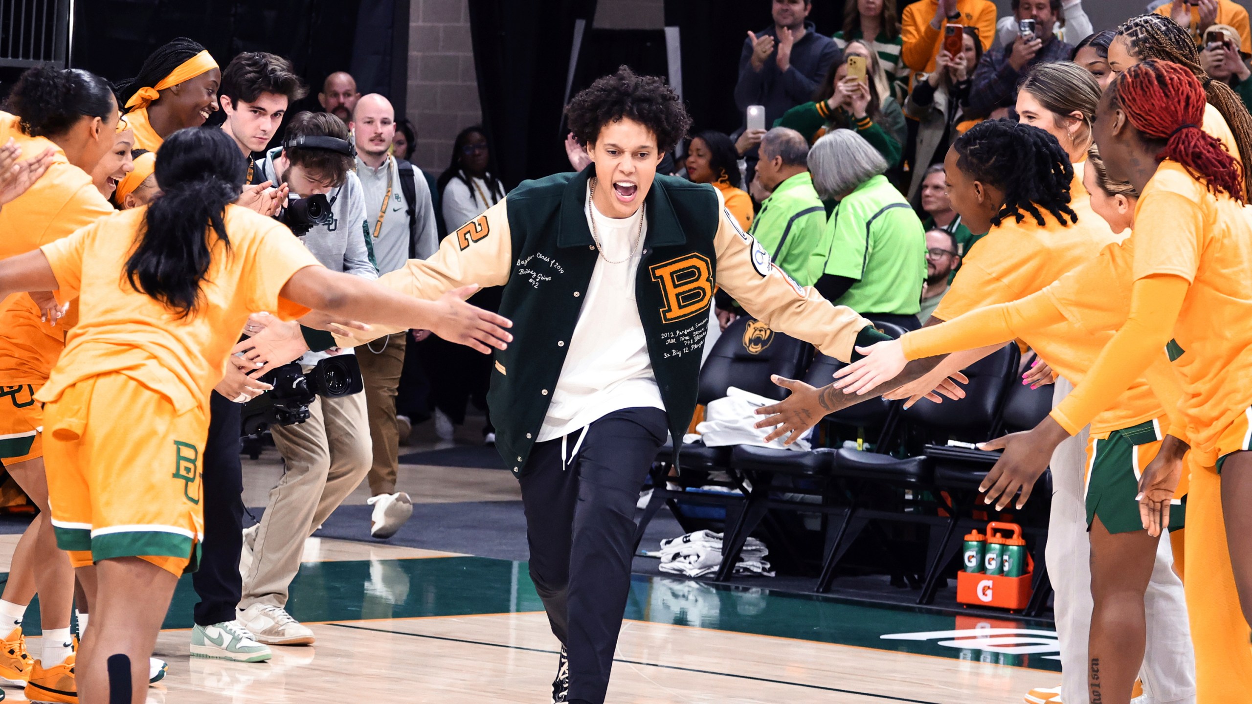 FILE - Former Baylor University legend and WNBA star Brittney Griner runs onto the court during her No. 42 jersey retirement ceremony before an NCAA college basketball game against Texas Tech, Sunday, Feb. 18, 2024, in Waco, Texas. A’ja Wilson, Breanna Stewart and Brittney Griner will be back on the courts chasing another WNBA title when camps open on Sunday, April 28. (Rod Aydelotte/Waco Tribune-Herald via AP, File)