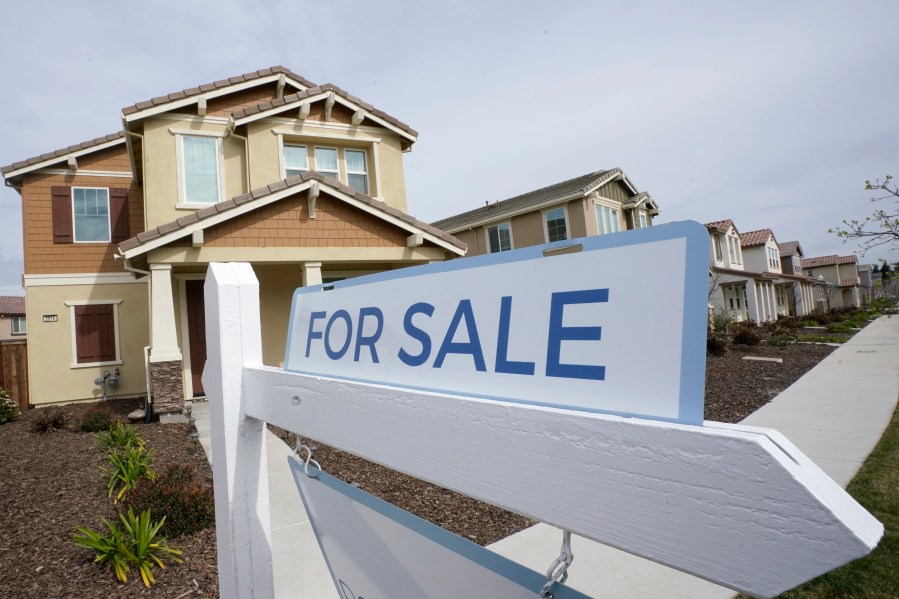 FILE - A for sale sign is posted in front of a home in Sacramento, Calif., Thursday, March 3, 2022. HomeServices of America, a real estate company owned by Warren Buffett’s Berkshire Hathaway, has agreed to pay $250 million to settle lawsuits nationwide claiming that longstanding practices by real estate brokerages forced U.S. homeowners to pay artificially inflated broker commissions when they sold their homes. (AP Photo/Rich Pedroncelli, File)