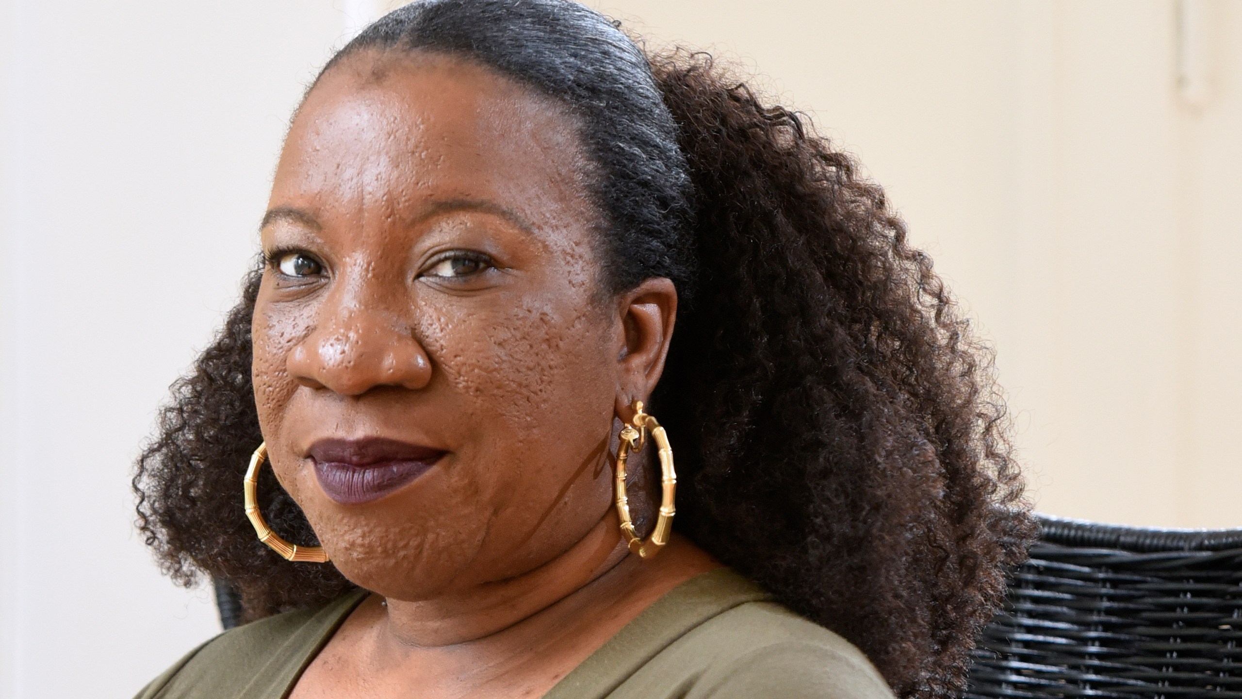 FILE - Tarana Burke, founder and leader of the #MeToo movement, sits in her home in Baltimore on Tuesday, Oct. 13, 2020. (AP Photo/Steve Ruark, File)