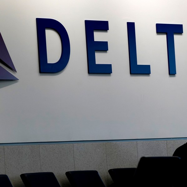 A man waits for a Delta Air Lines flight at Hartsfield-Jackson International Airport in Atlanta, Jan. 7, 2022.