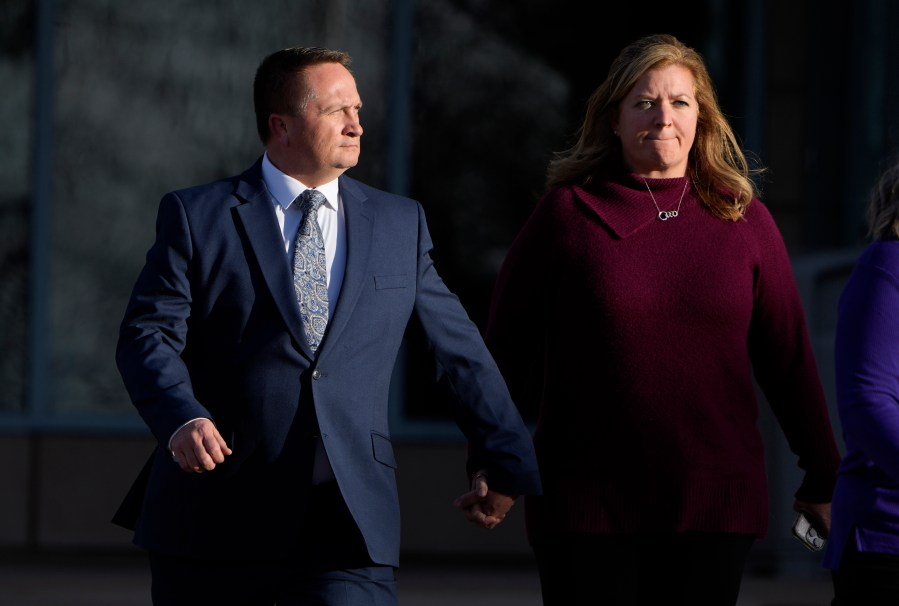 FILE - Paramedic Jeremy Cooper, left, enters the Adams County, Colo., Justice Center, Dec. 22, 2023, in Brighton, Colo. The former Aurora Fire Department paramedic faces up to three years in prison when he is scheduled to be sentenced Friday, April 26, 2024, for criminally negligent homicide in Elijah McClain's death. (AP Photo/David Zalubowski, File)