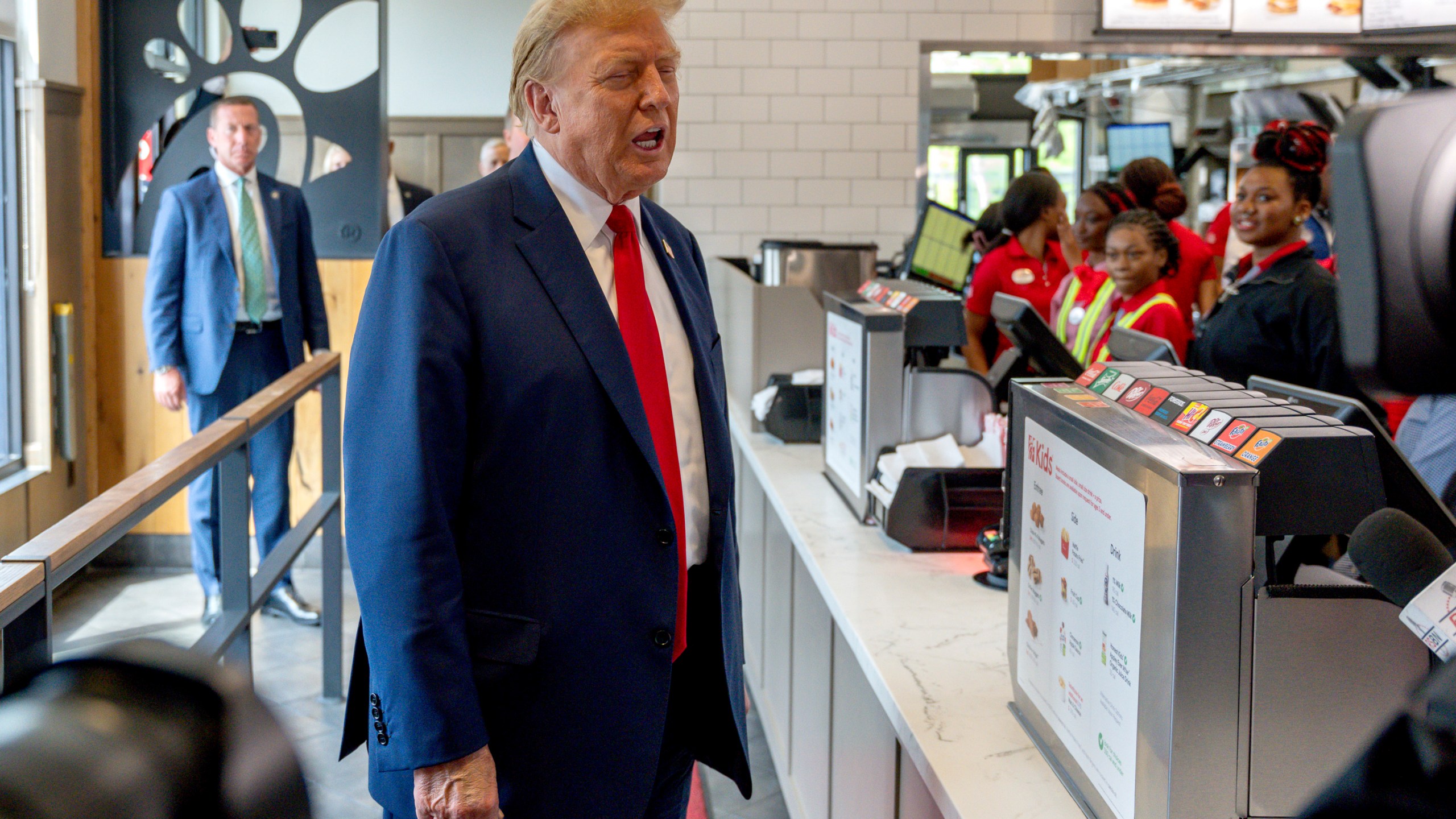 FILE - Republican presidential candidate former President Donald Trump visits a Chick-fil-A eatery, April 10, 2024, in Atlanta. Five months before the first general election votes are cast, Trump's campaign has little to show for its ambitious minority outreach plan. Trump advisers point to Trump's appearances at the eatery, as well as a New York bodega and a New York City police officer's wake as examples of the campaign's developing outreach strategy that hinges on using Trump's celebrity and bombastic personality to create viral moments in communities of color. (AP Photo/Jason Allen, File)