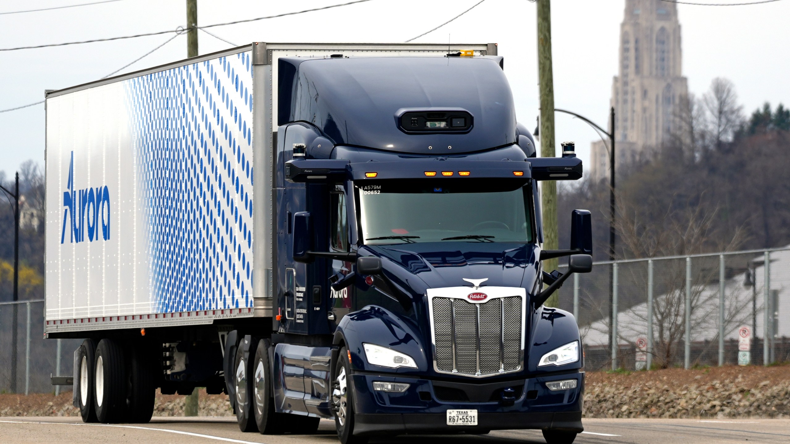 A self-driving tractor trailer maneuvers around a test track in Pittsburgh, Thursday, March 14, 2024. The truck, outfitted with 25 laser, radar and camera sensors, is owned by Pittsburgh-based Aurora Innovation Inc. Late this year, Aurora plans to start hauling freight on Interstate 45 between the Dallas and Houston areas with 20 driverless trucks. (AP Photo/Gene J. Puskar)