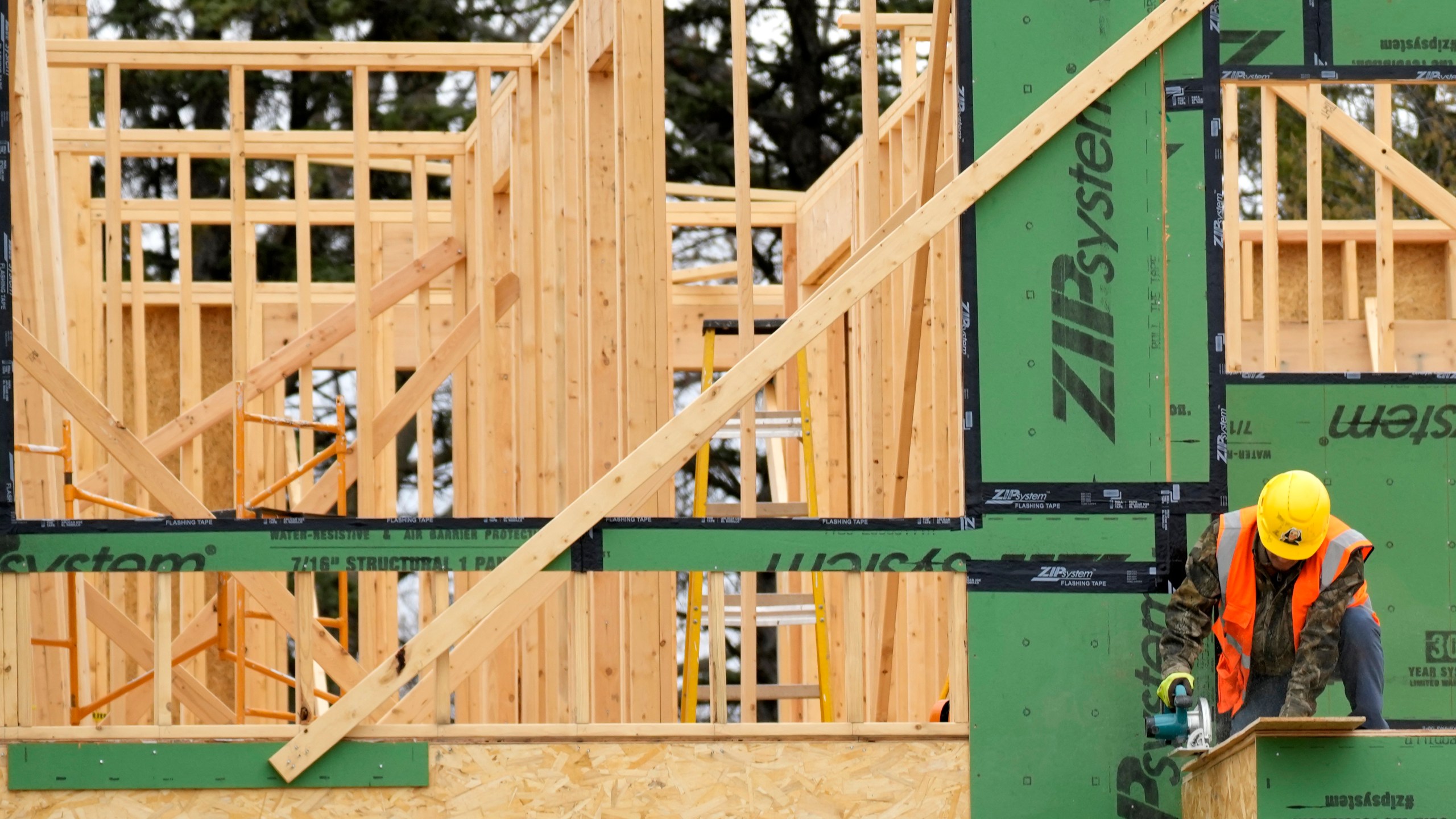 A construction workers cuts wood at a residential building site in Mount Prospect, Ill., Monday, March 18, 2024. On Tuesday, April 30, 2024, the Labor Department reports on wages and benefits for U.S. workers during the first quarter of 2024. (AP Photo/Nam Y. Huh)