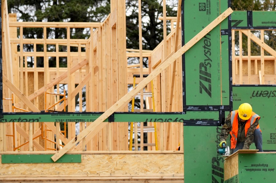 A construction workers cuts wood at a residential building site in Mount Prospect, Ill., Monday, March 18, 2024. On Tuesday, April 30, 2024, the Labor Department reports on wages and benefits for U.S. workers during the first quarter of 2024. (AP Photo/Nam Y. Huh)