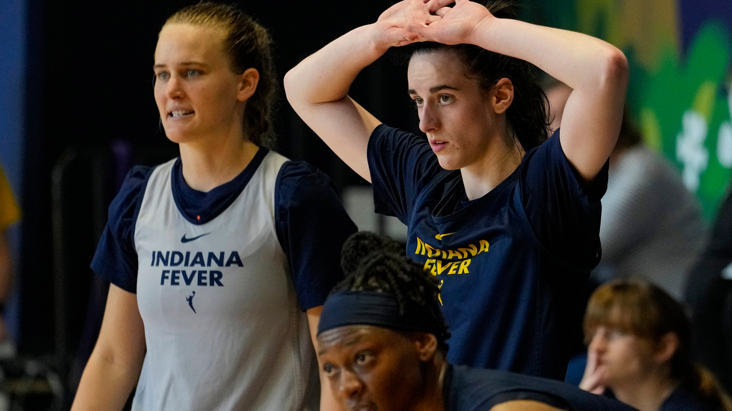 Indiana Fever guard Caitlin Clark, top right, watches from the sideline as the WNBA basketball team practices in Indianapolis, Sunday, April 28, 2024. (AP Photo/Michael Conroy)