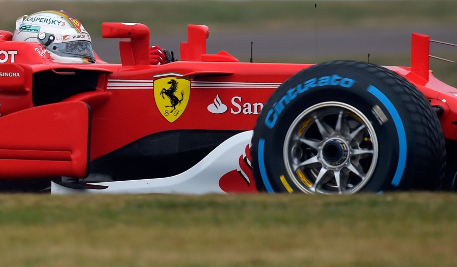 FILE - Sebastian Vettel steers the Ferrari Formula One SF70H racer at the Ferrari Fiorano private test track in Maranello, Italy, Feb. 24, 2017. Short-term rental giant Airbnb is listing 11 iconic locations, including a night at the Ferrari Museum in Maranello, in a splashy new marketing campaign. (AP Photo/Marco Vasini, File)