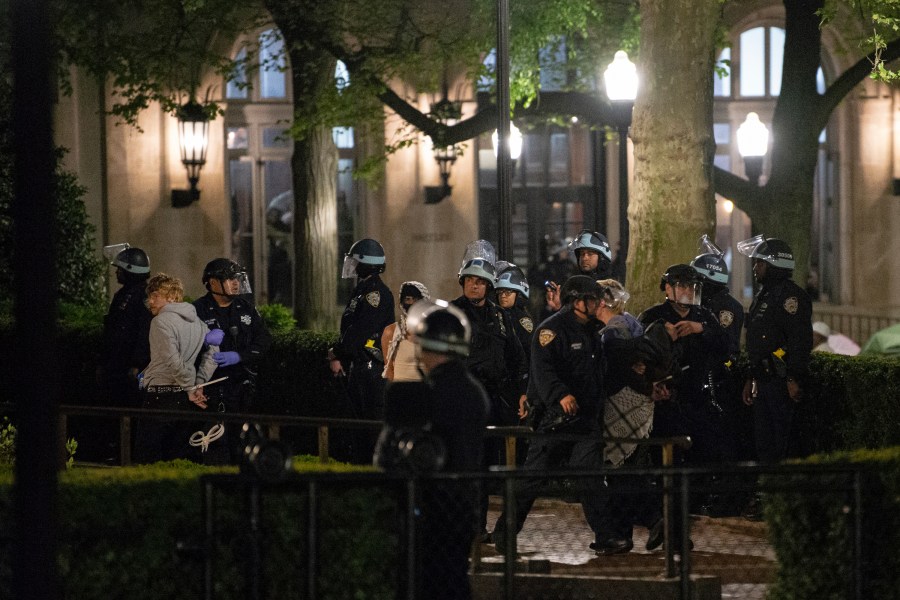 Officers with the New York Police Department arrest Pro-Palestinian protesters at Columbia University, Tuesday, April 30, 2024, in New York. The protesters had seized the administration building, known as Hamilton Hall, more than 20 hours earlier in a major escalation as demonstrations against the Israel-Hamas war spread on college campuses nationwide. (Marco Postigo Storel via AP)