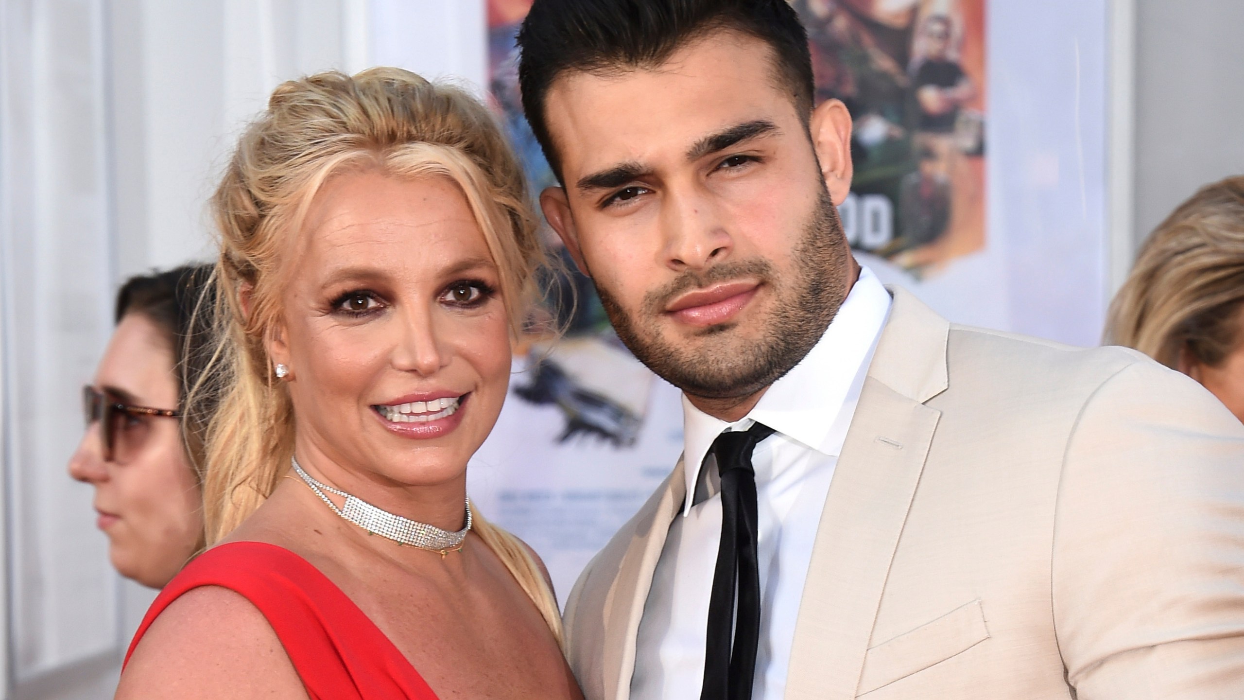 FILE - Britney Spears and Sam Asghari appear at the Los Angeles premiere of "Once Upon a Time in Hollywood" on July 22, 2019. Spears has reached a divorce settlement with her soon-to-be-ex-husband Asghari. (Photo by Jordan Strauss/Invision/AP, File)