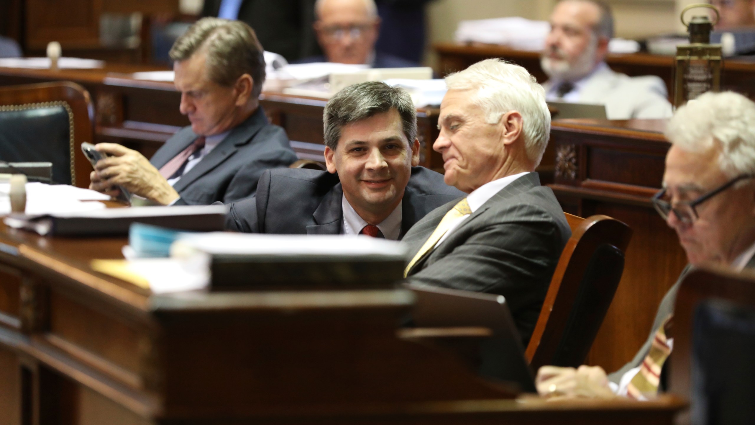 South Carolina Senate Majority Leader Shane Massey, R-Edgefield, left, and Sen. Chip Campsen, R-Isle of Palms, right, talk as the Senate debates a bill that would ban gender-affirming care for transgender minors on Wednesday, May 1, 2024, in Columbia, S.C. (AP Photo/Jeffrey Collins)