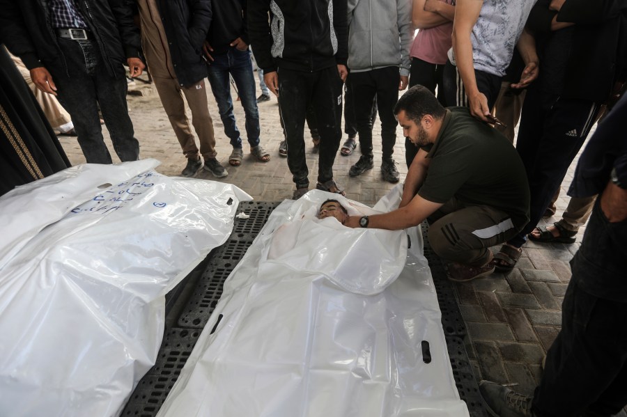 The Chahine family prepares to bury two adults and five boys and girls under the age of 16 after an overnight Israeli strike in Rafah, southern Gaza Strip, Friday, May 3, 2024. An Israeli strike on the city of Rafah on the southern edge of the Gaza Strip killed several people, including children, hospital officials said Friday. (AP Photo/Ismael Abu Dayyah)