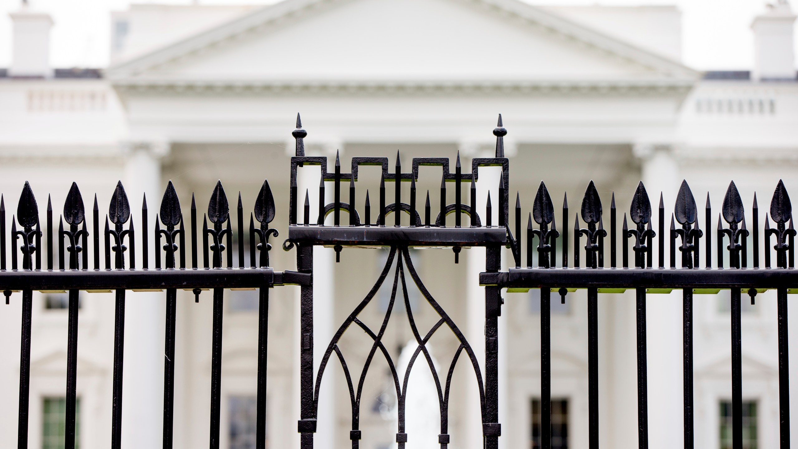 FILE - The White House is visible through the fence at the North Lawn in Washington, on June 16, 2016. A driver died Saturday night, May 4, 2024 after crashing a vehicle into a gate at the White House, authorities said. (AP Photo/Andrew Harnik, File)