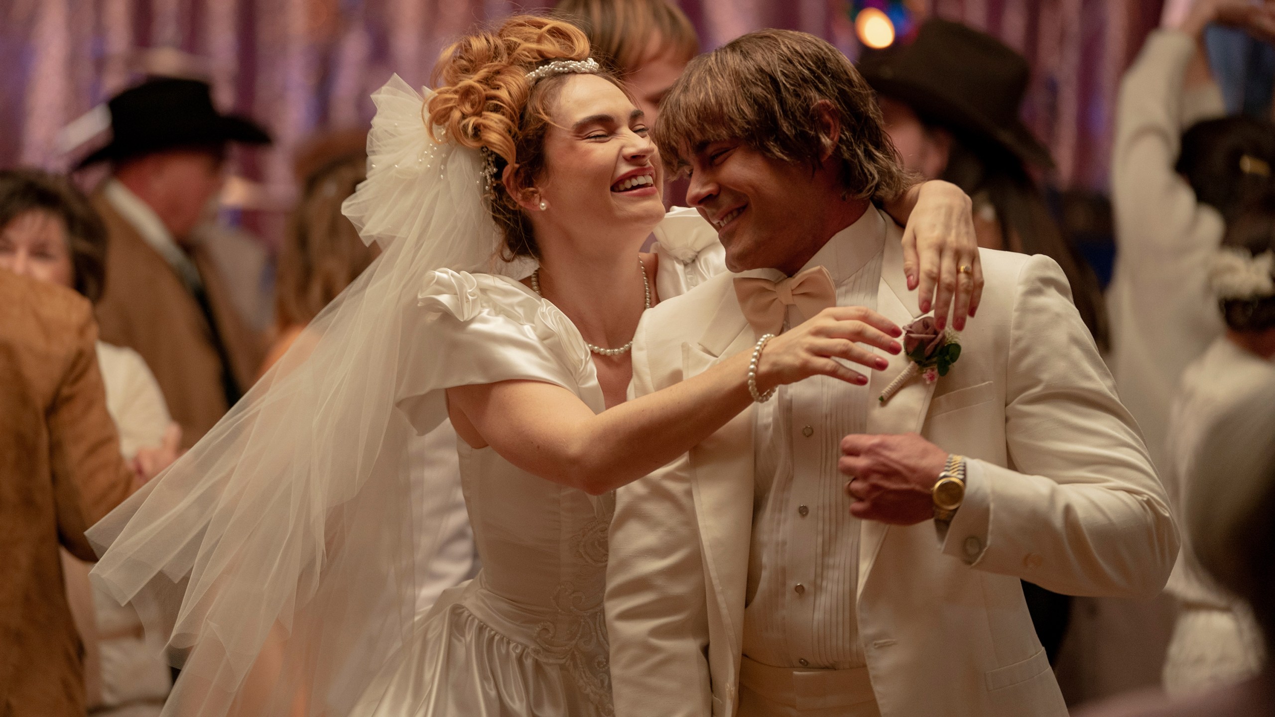 This image released by A24 shows Lily James, left, and Zac Efron in a scene from "The Iron Claw." (Brian Roedel/A24 via AP)