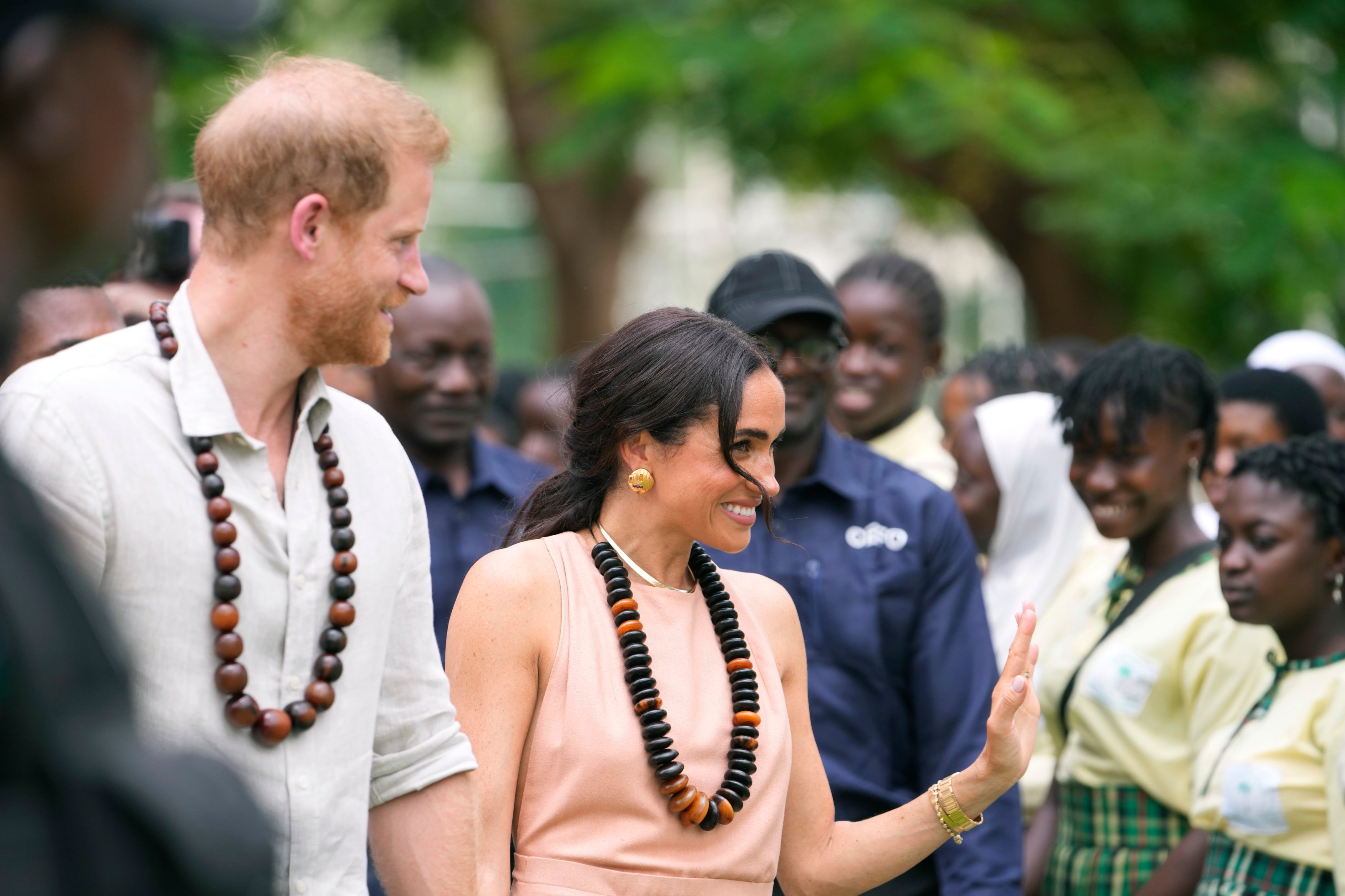 Prince Harry and Meghan visit children at the Lights Academy in Abuja, Nigeria, Friday, May 10, 2024. Prince Harry and his wife Meghan have arrived in Nigeria to champion the Invictus Games, which he founded to aid the rehabilitation of wounded and sick servicemembers and veterans. (AP Photo/Sunday Alamba)