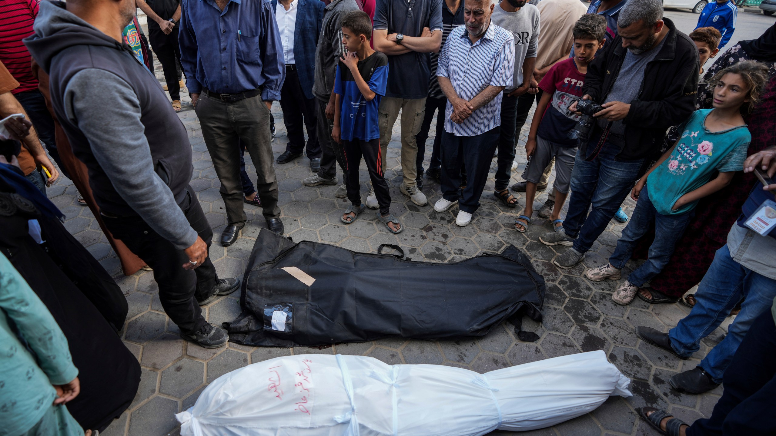 Palestinians mourn their relatives killed in the Israeli bombardments of the Gaza Strip in front of the morgue of the Al Aqsa Hospital in Deir al Balah, Gaza Strip, on Sunday, May 12, 2024. (AP Photo/Abdel Kareem Hana)