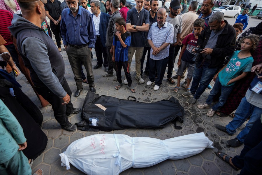 Palestinians mourn their relatives killed in the Israeli bombardments of the Gaza Strip in front of the morgue of the Al Aqsa Hospital in Deir al Balah, Gaza Strip, on Sunday, May 12, 2024. (AP Photo/Abdel Kareem Hana)