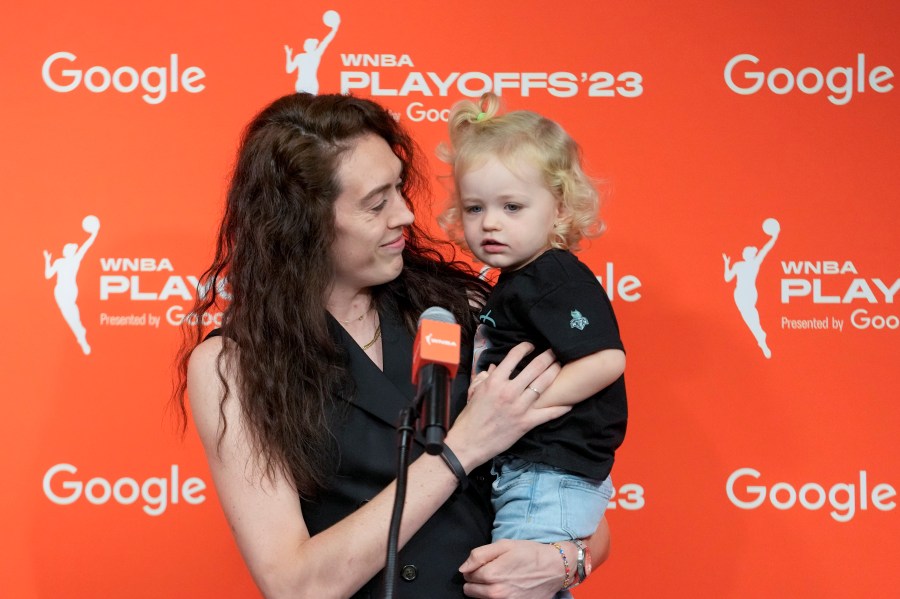 FILE - New York Liberty forward Breanna Stewart holds her daughter Ruby while speaking to reporters, Sept. 26, 2023, at Barclays Center in New York. Stewart, who has two children with wife Marta, appreciates the WNBA's new travel perk of charter flights — as well as other benefits for parents under the current Collective Bargaining Agreement. (AP Photo/Mary Altaffer, File)