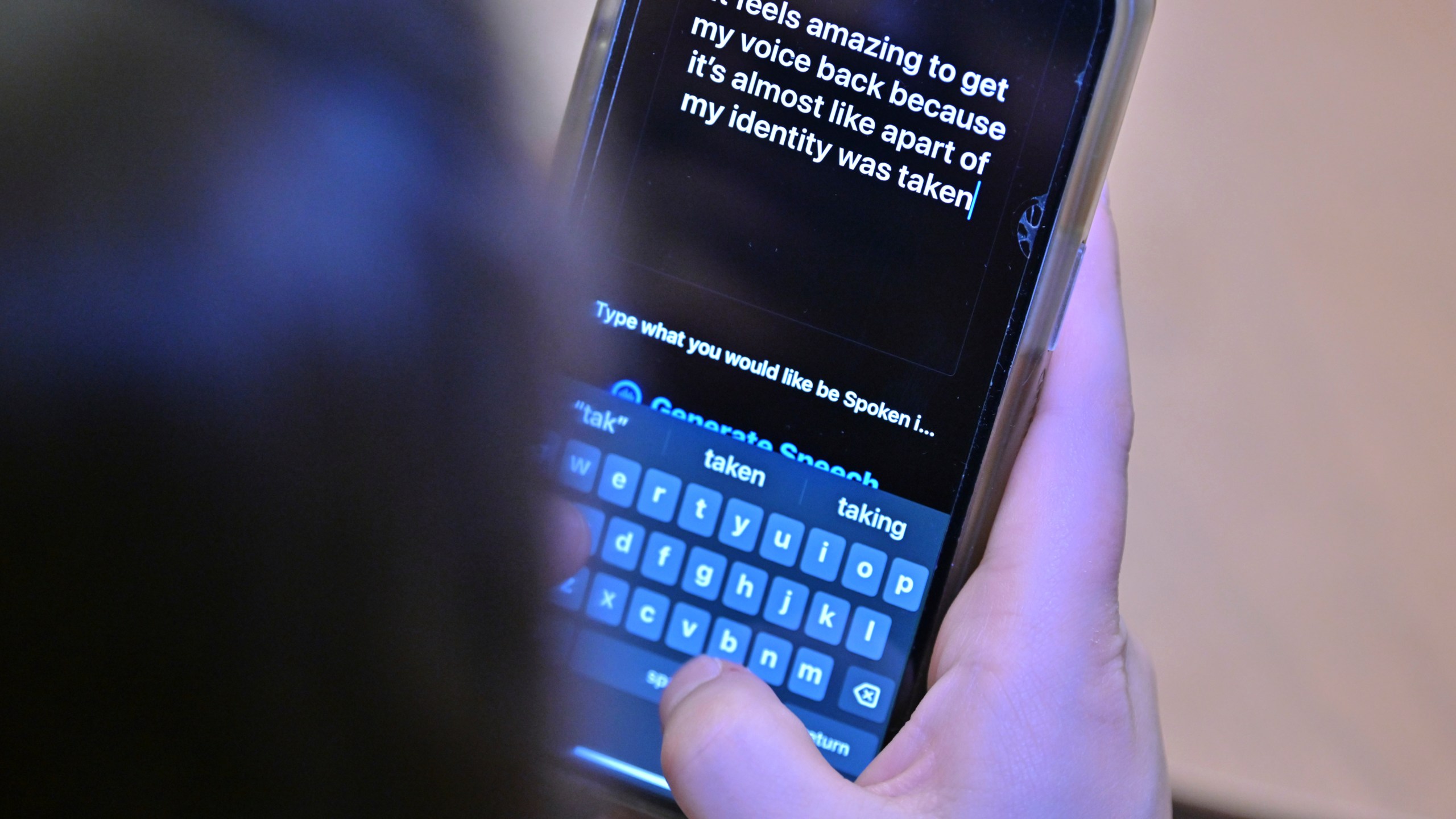 Alexis Bogan types a response to a reporter's question with an app which approximates her lost voice, Thursday, March 11, 2024, at Rhode Island Hospital in Providence, R.I. Doctors treating Bogan, whose speech was impaired by a brain tumor, used a voice-cloning tool from OpenAI to recreate her previous voice. (AP Photo/Josh Reynolds)