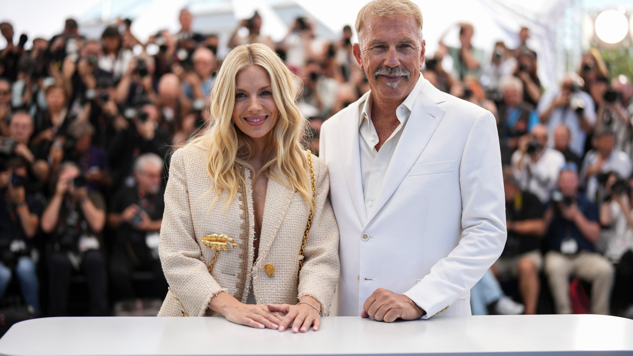 Sienna Miller, left, and Kevin Costner pose for photographers at the photo call for the film 'Horizon: An American Saga' at the 77th international film festival, Cannes, southern France, Sunday, May 19, 2024. (Photo by Scott A Garfitt/Invision/AP)